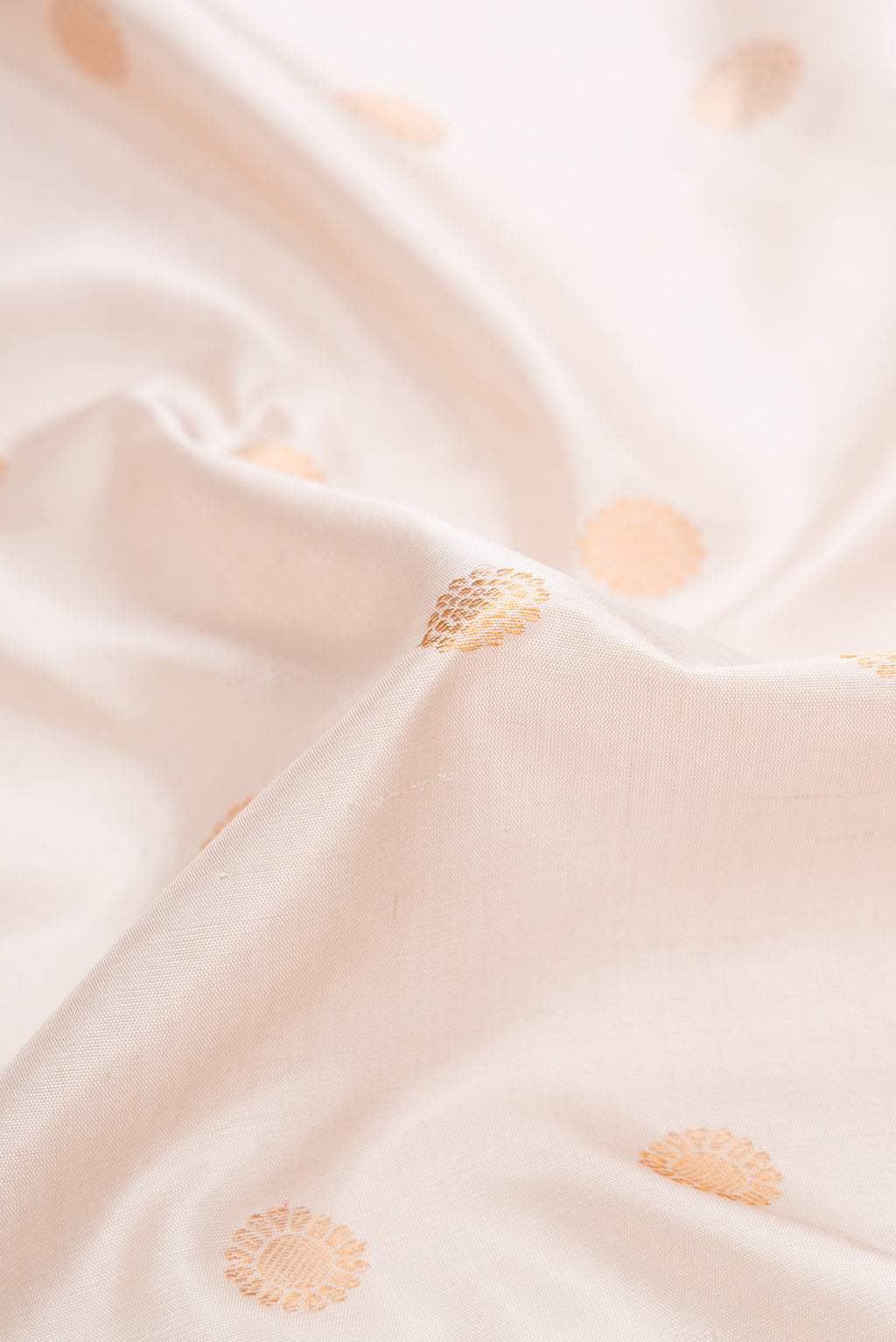 Close up of Beige Dual Tone Gadwal Silk Saree with Zari Butta on the body and Zari Border.  displaying folds