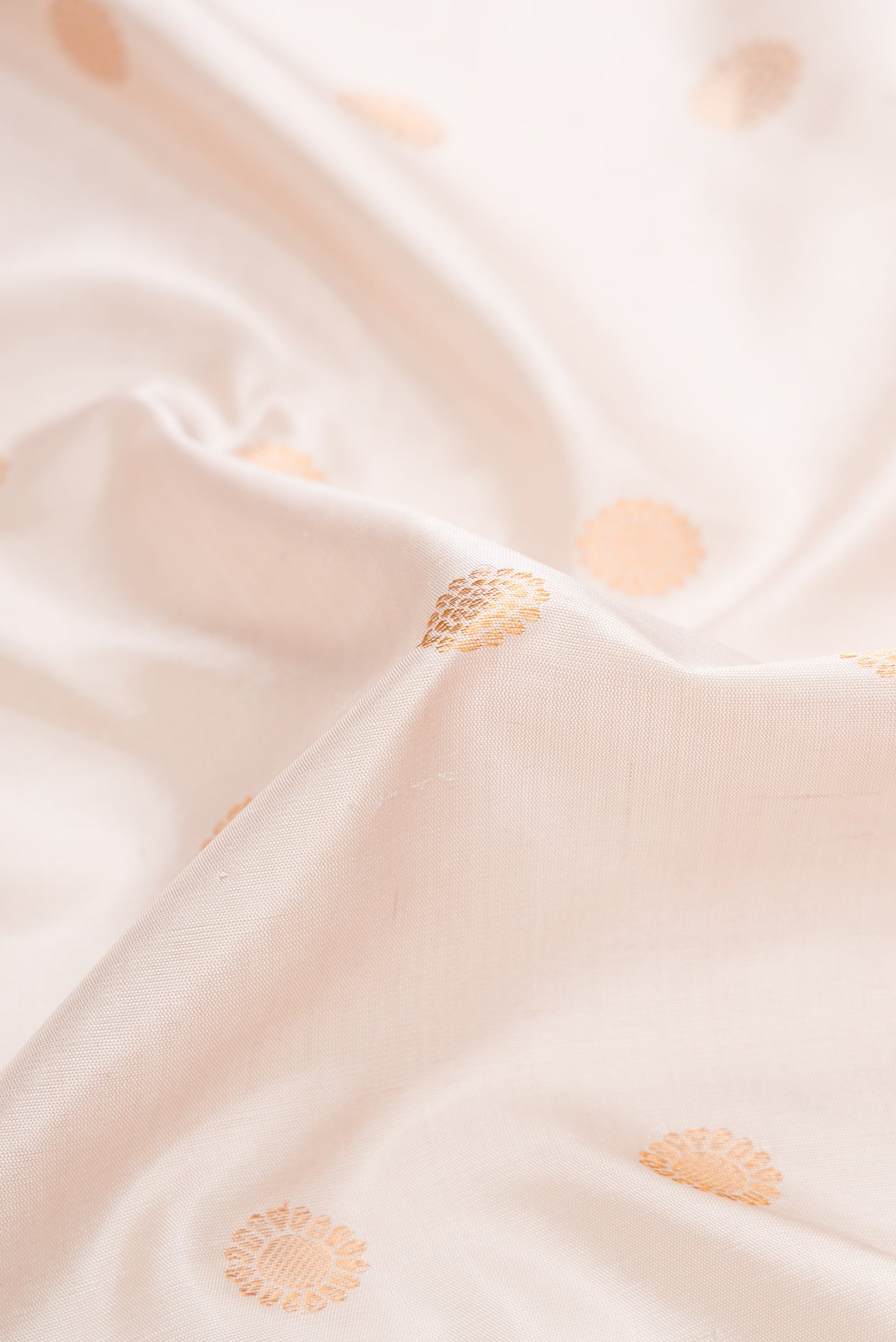 Close up of Beige Dual Tone Gadwal Silk Saree with Zari Butta on the body and Zari Border.  displaying folds