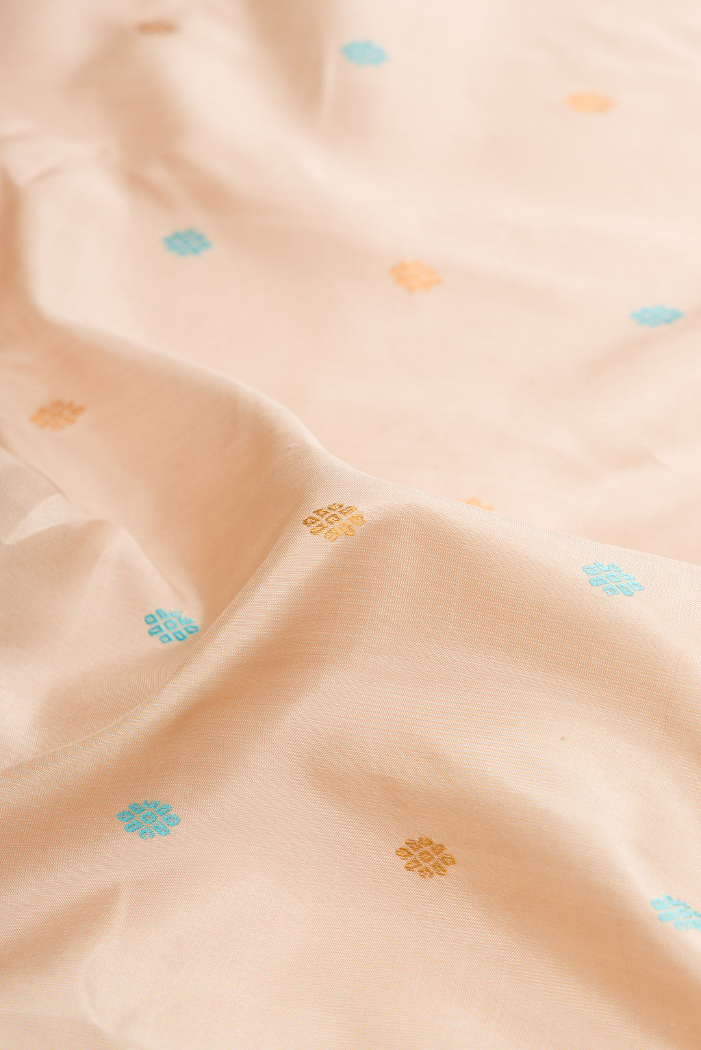Close up of Dark Beige Dual Tone Gadwal Silk Saree with Zari And Thread Butta on the body and Zari Border.  displaying folds