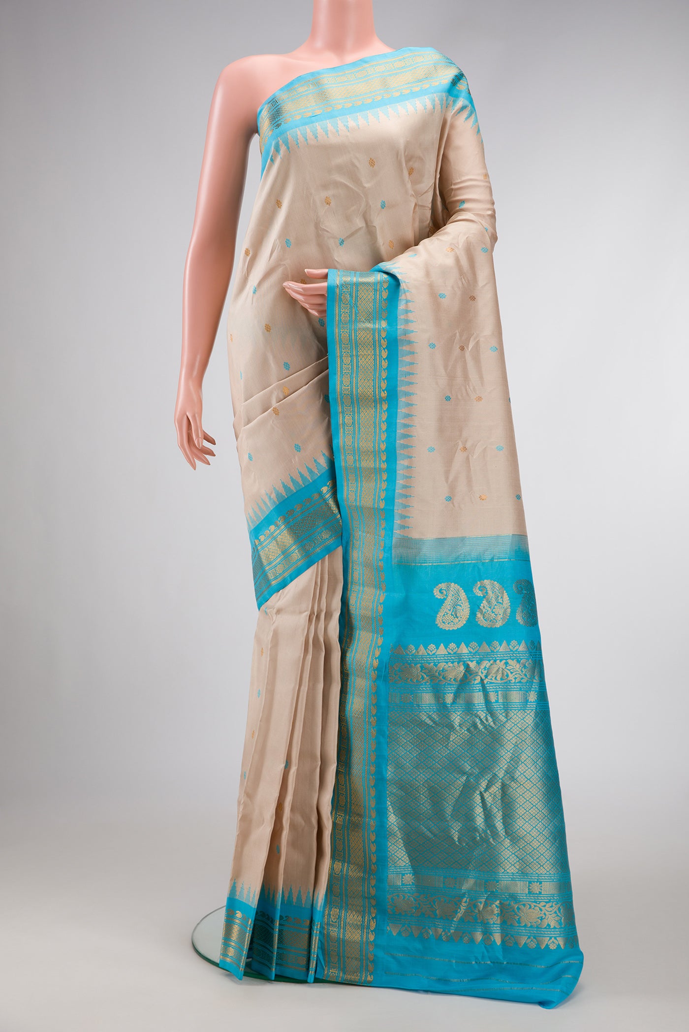 Dark Beige Dual Tone Gadwal Silk Saree with Zari And Thread Butta on the body and Zari Border.  displayed on a mannequin