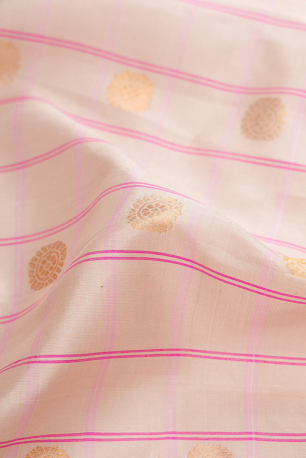 Close up of Beige Dual Tone Gadwal Silk Saree with Checked design on the body and Zari Border.  displaying folds