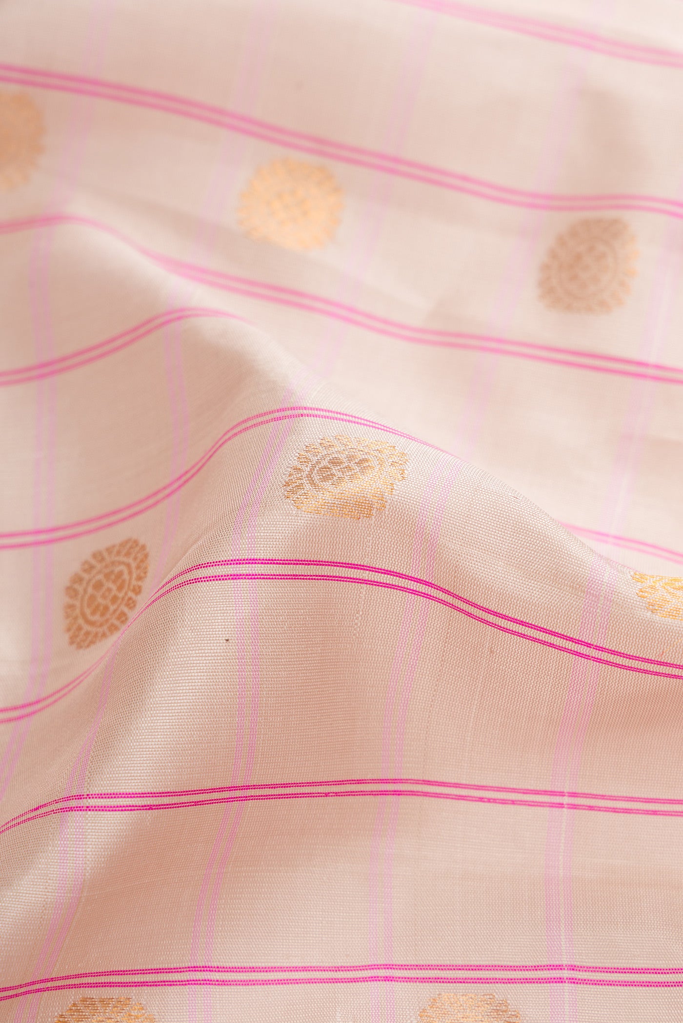 Close up of Beige Dual Tone Gadwal Silk Saree with Checked design on the body and Zari Border.  displaying folds