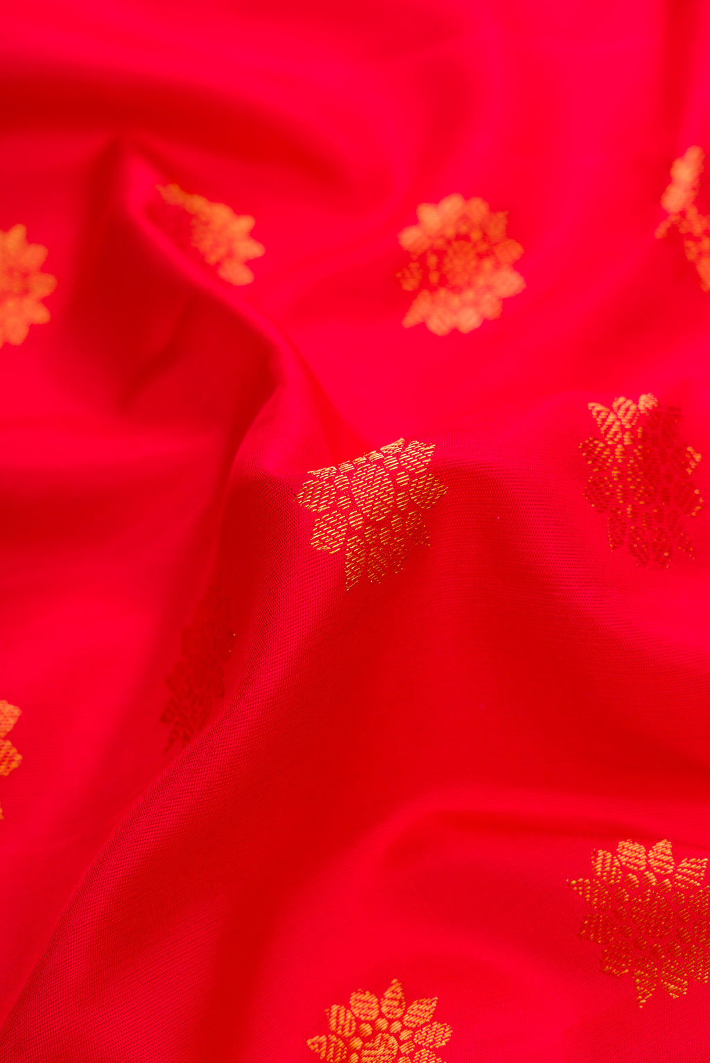 Close up of Red Dual Tone Gadwal Silk Saree with Zari Butta on the body and Zari Border.  displaying folds