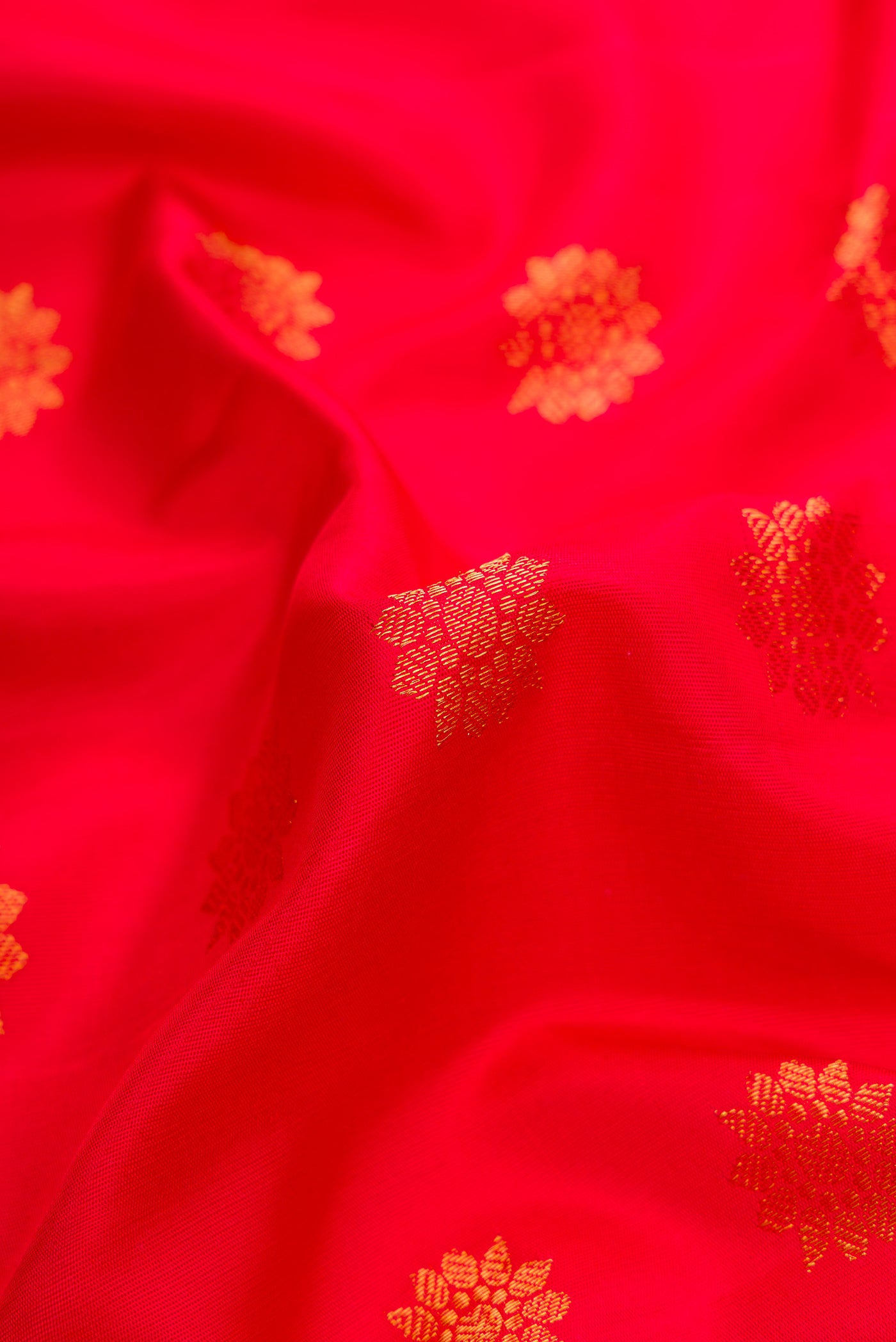 Close up of Red Dual Tone Gadwal Silk Saree with Zari Butta on the body and Zari Border.  displaying folds