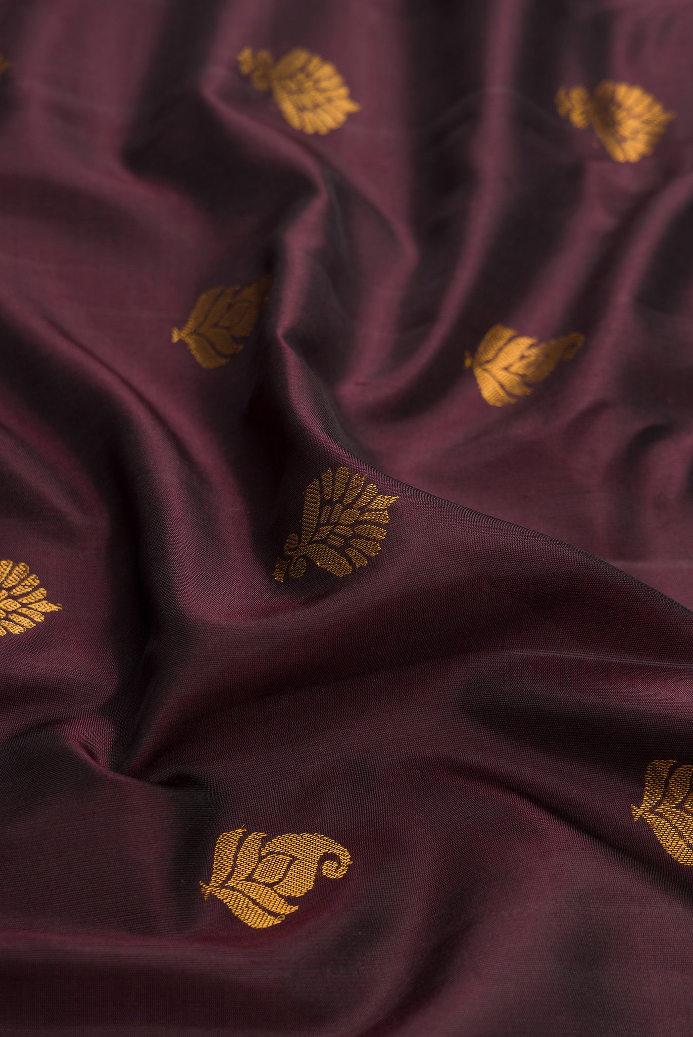 Close up of Coffee Brown Dual Tone Gadwal Silk Saree with Zari Butta on the body and Zari Border.  displaying folds