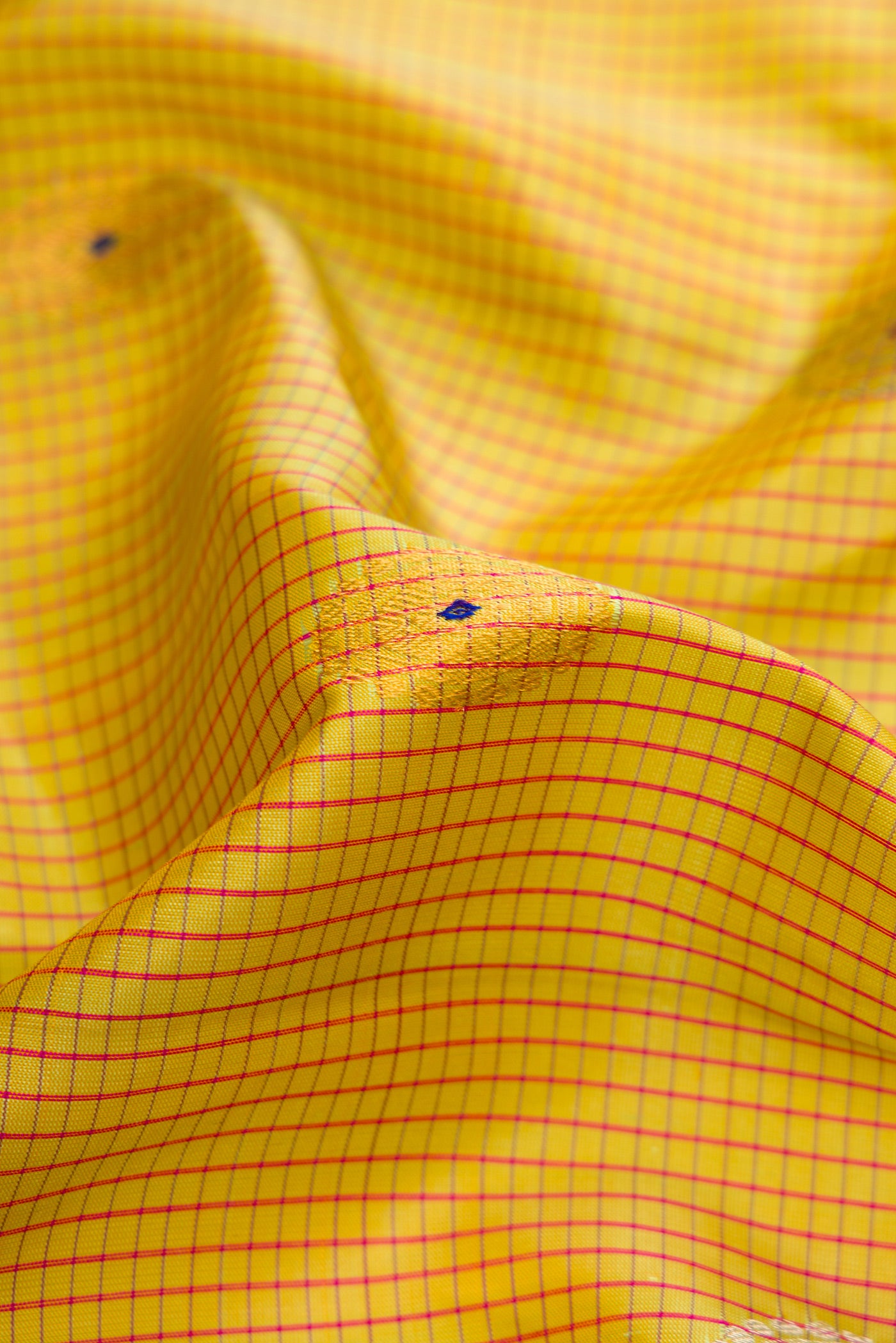 Close up of Mehandi Green Dual Tone Gadwal Silk Saree with Zari And Thread Butta on the body and Zari Border.  displaying folds