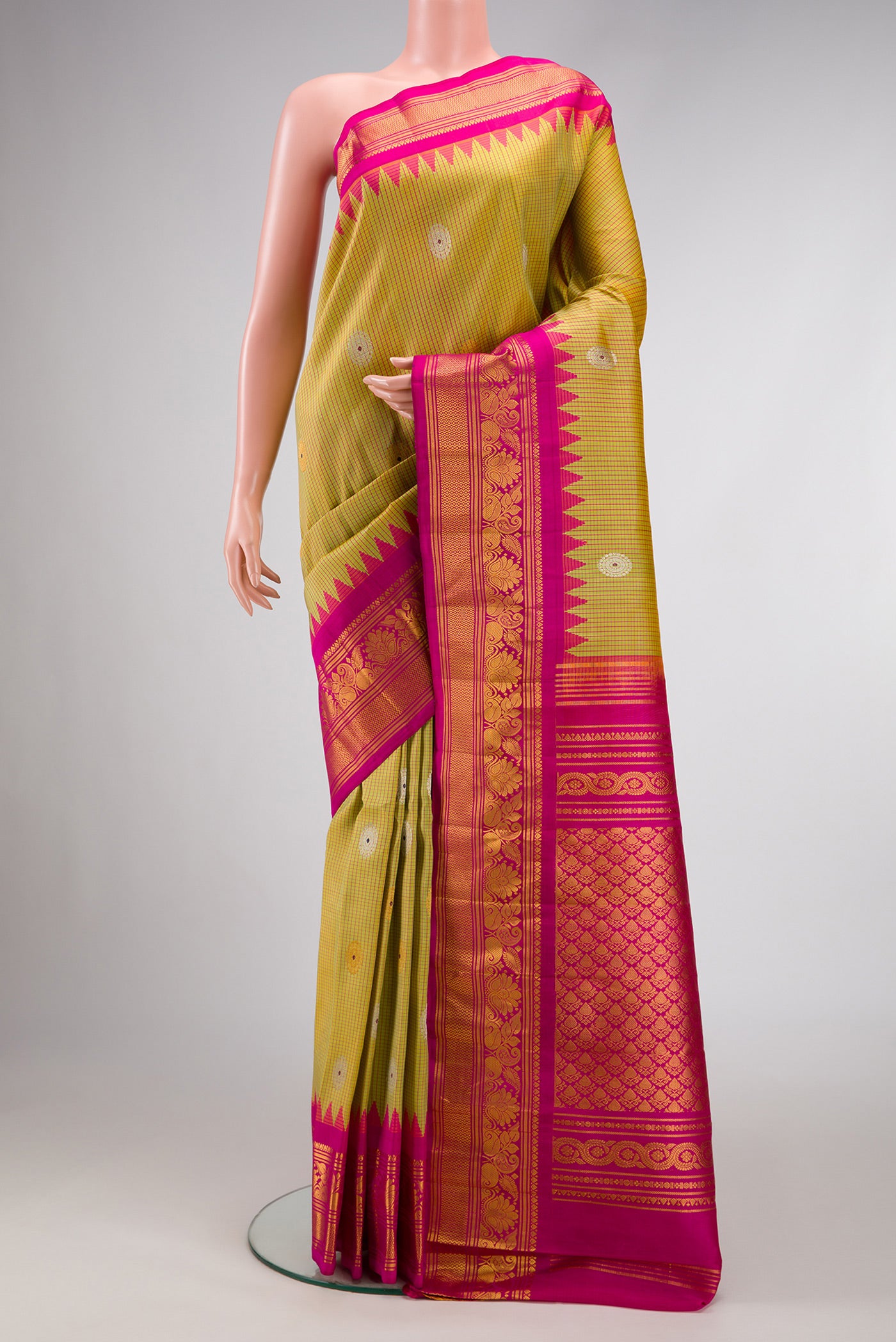 Mehandi Green Dual Tone Gadwal Silk Saree with Zari And Thread Butta on the body and Zari Border.  displayed on a mannequin