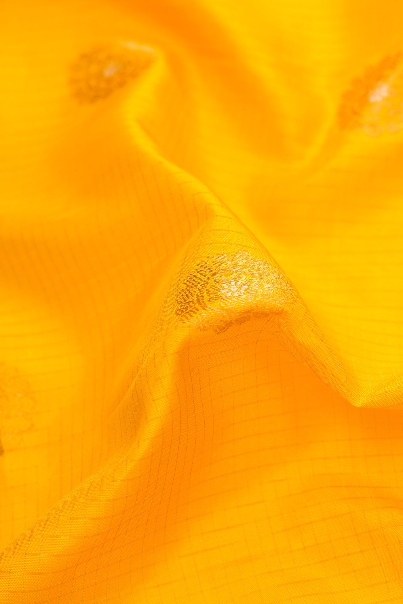 Close up of Yellow Dual Tone Gadwal Silk Saree with Zari Butta on the body and Zari Border.  displaying folds