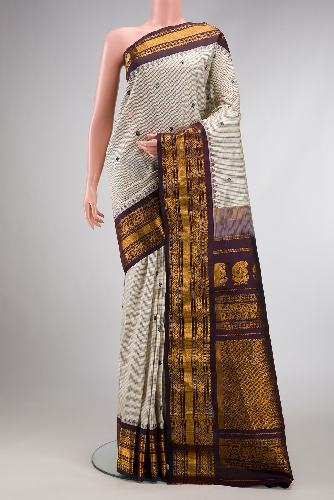 Grey Dual Tone Gadwal Silk Saree with Zari And Thread Butta on the body and Zari Border.  displayed on a mannequin