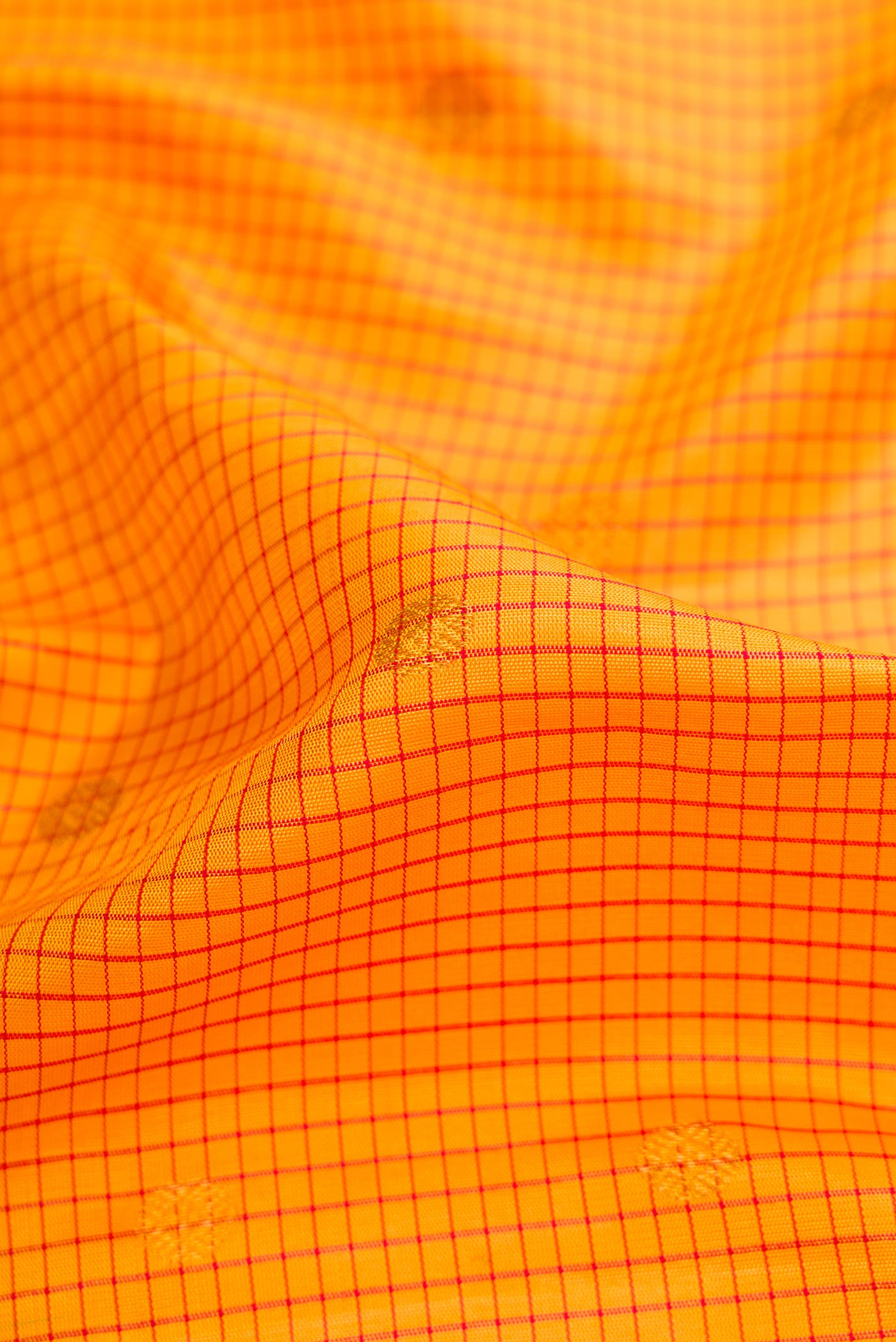 Close up of Mustard Dual Tone Gadwal Silk Saree with Checked design on the body and Zari Border.  displaying folds
