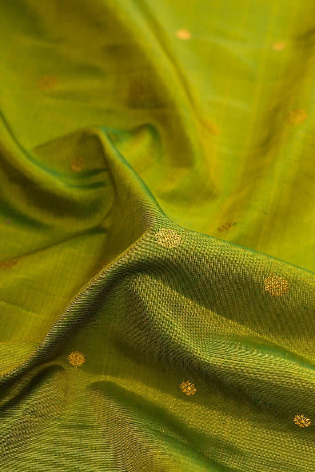 Close up of Green Dual Tone Gadwal Silk Saree with Zari Butta on the body and Fancy Border.  displaying folds