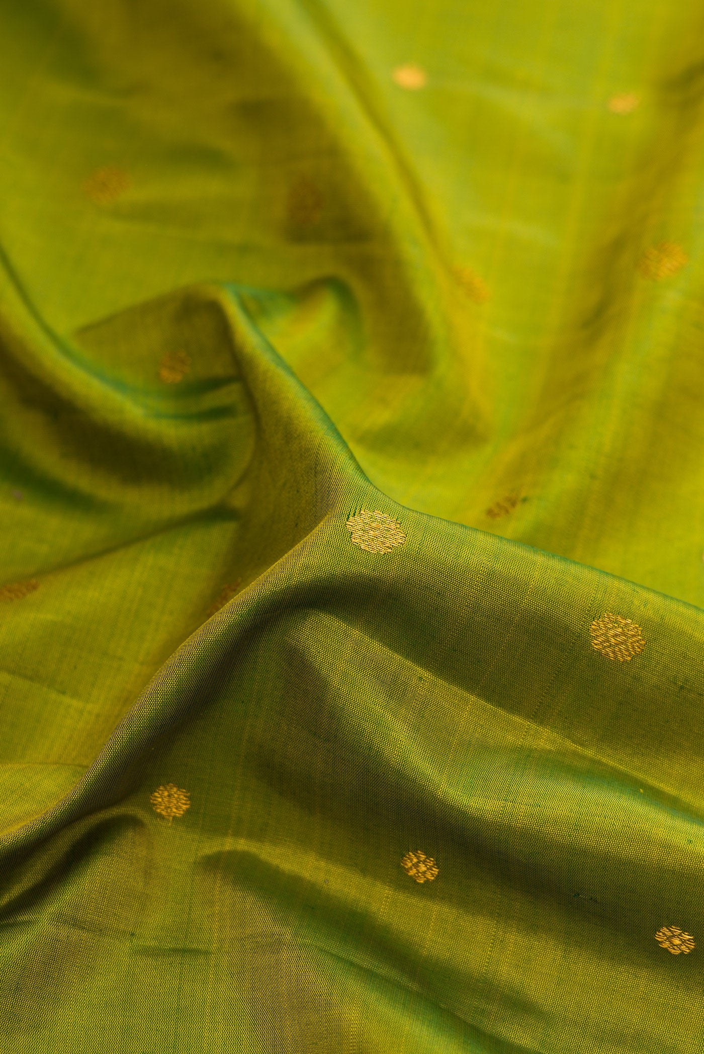 Close up of Green Dual Tone Gadwal Silk Saree with Zari Butta on the body and Fancy Border.  displaying folds