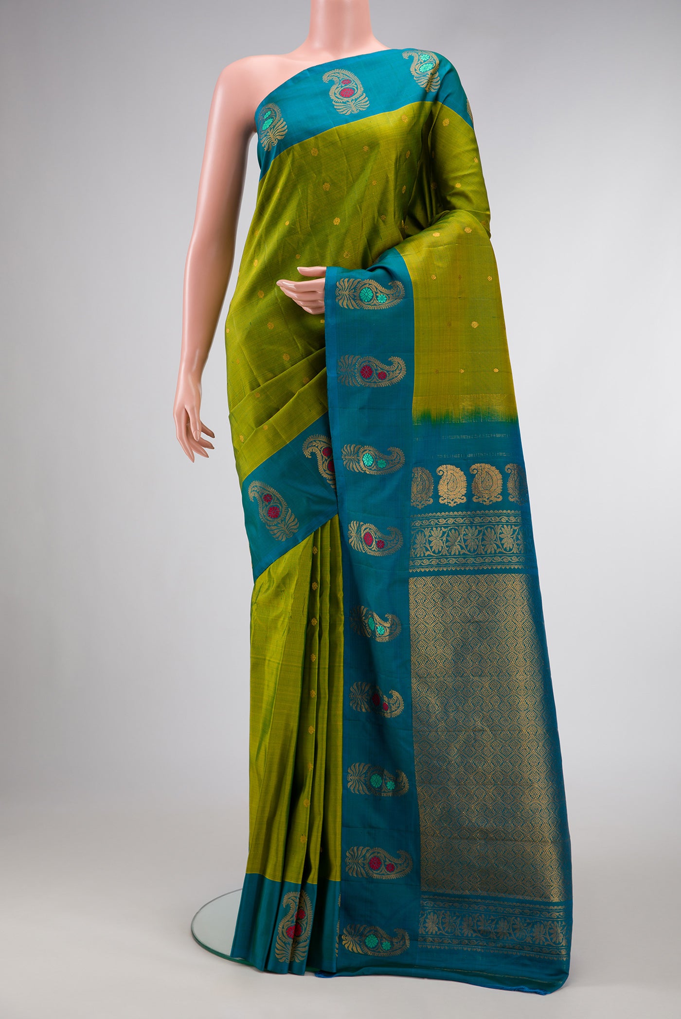 Green Dual Tone Gadwal Silk Saree with Zari Butta on the body and Fancy Border.  displayed on a mannequin