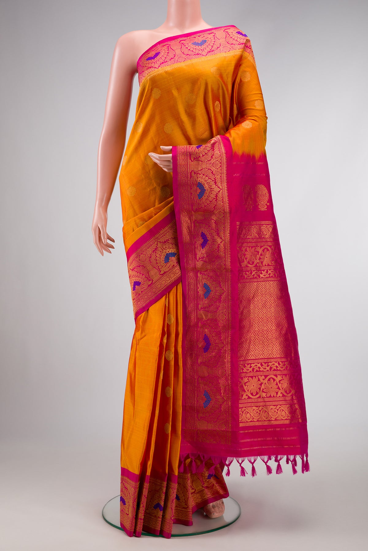 Mustard Dual Tone Gadwal Silk Saree with Zari Butta on the body and Zari Border.  displayed on a mannequin