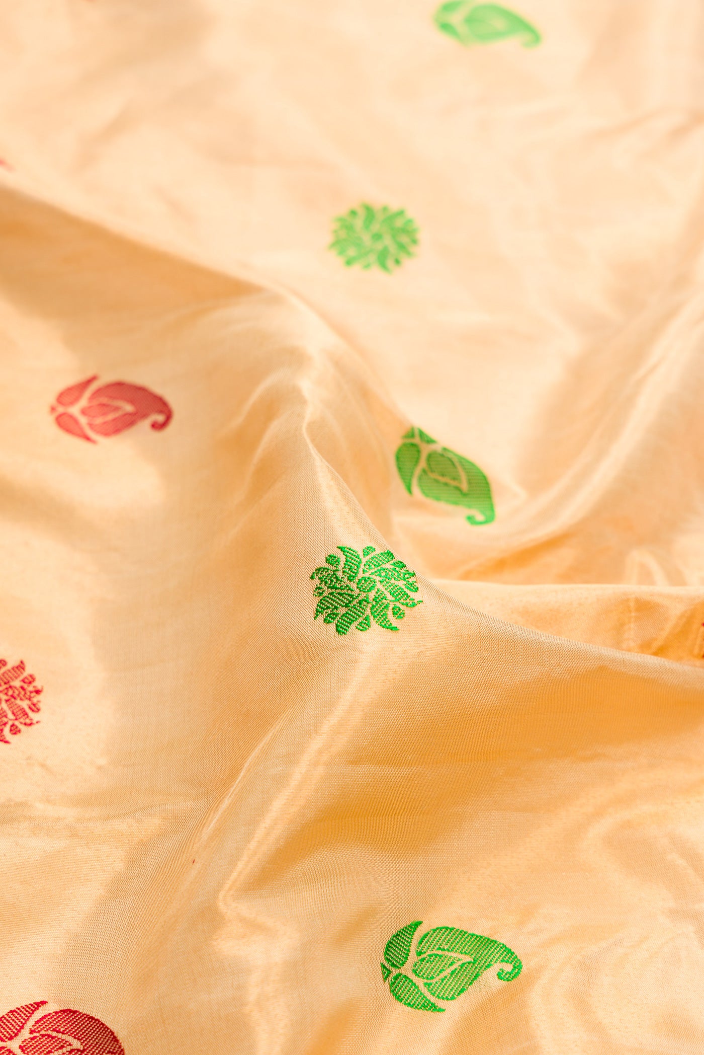 Close up of Gold Dual Tone Gadwal Silk Saree with Zari And Thread Butta on the body and Zari And Thread Border.  displaying folds