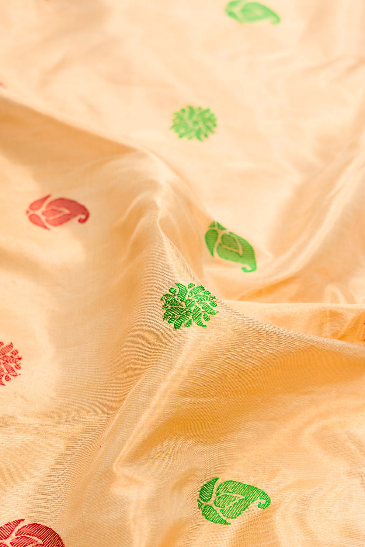 Close up of Gold Dual Tone Gadwal Silk Saree with Zari And Thread Butta on the body and Zari And Thread Border.  displaying folds