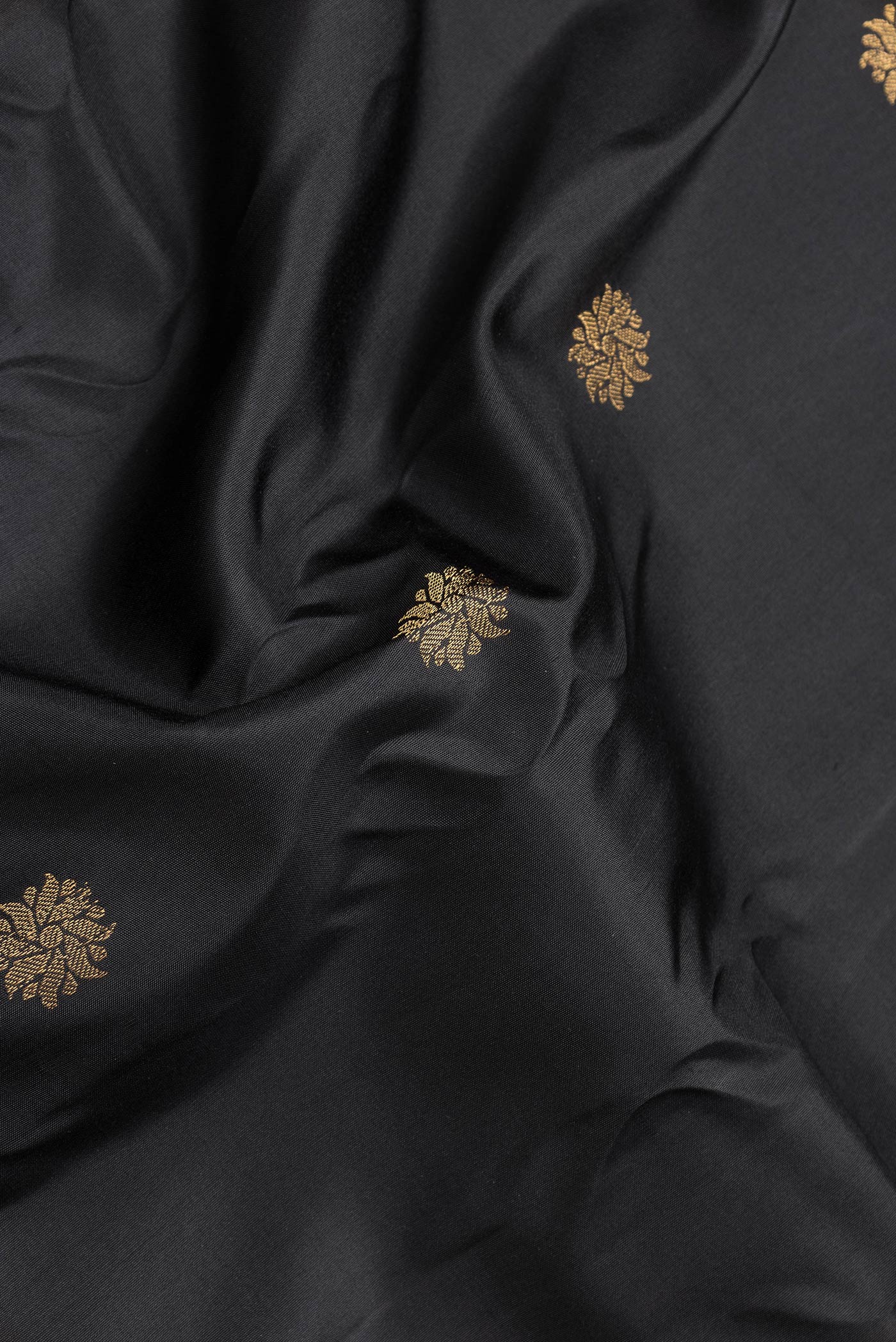 Close up of Black Dual Tone Gadwal Silk Saree with Zari Butta on the body and Zari Border.  displaying folds