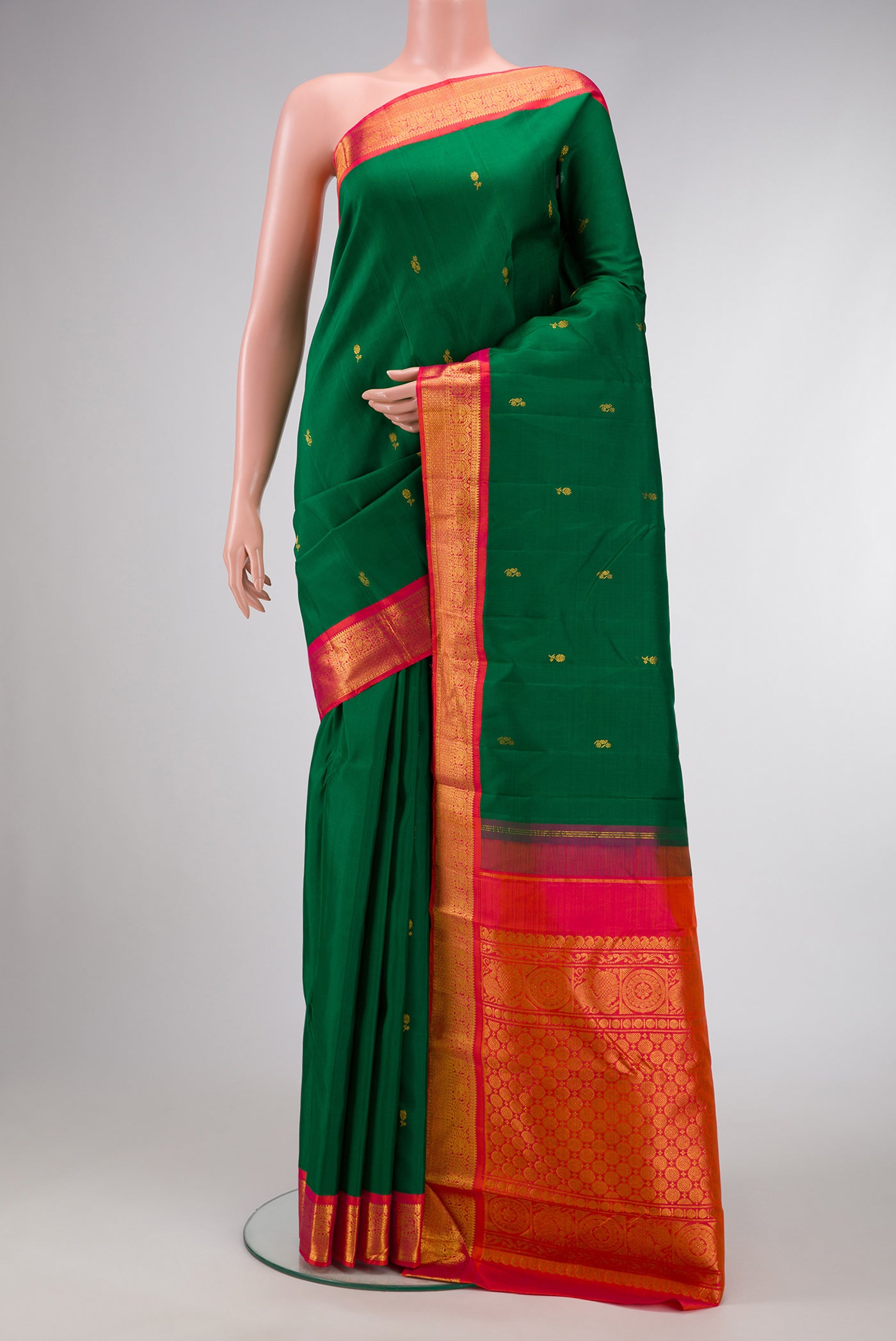 Green Dual Tone Kanjivaram Silk Saree with Zari Butta on the body and Zari Border.  displayed on a mannequin