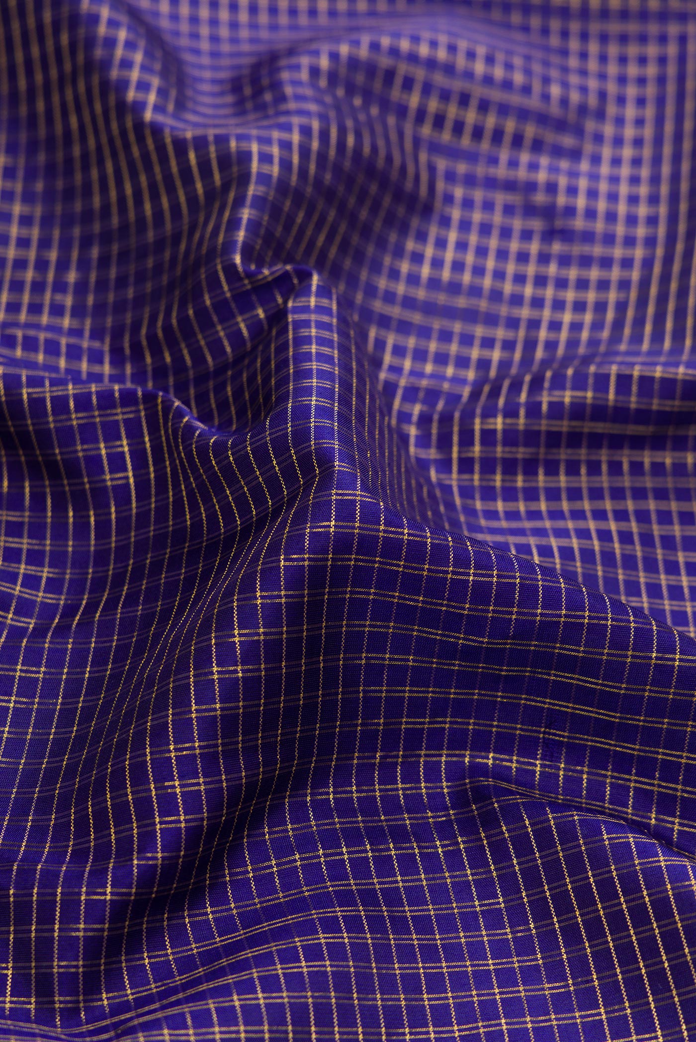 Close up of Violet Dual Tone Kanjivaram Silk Saree with Stripes on the body and Zari Border.  displaying folds