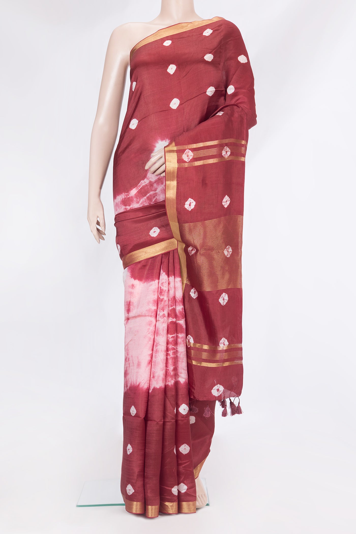 Maroon Dual Tone Blended Tussar Silk Saree with Bandhani Print on the body and Zari Border.  displayed on a mannequin