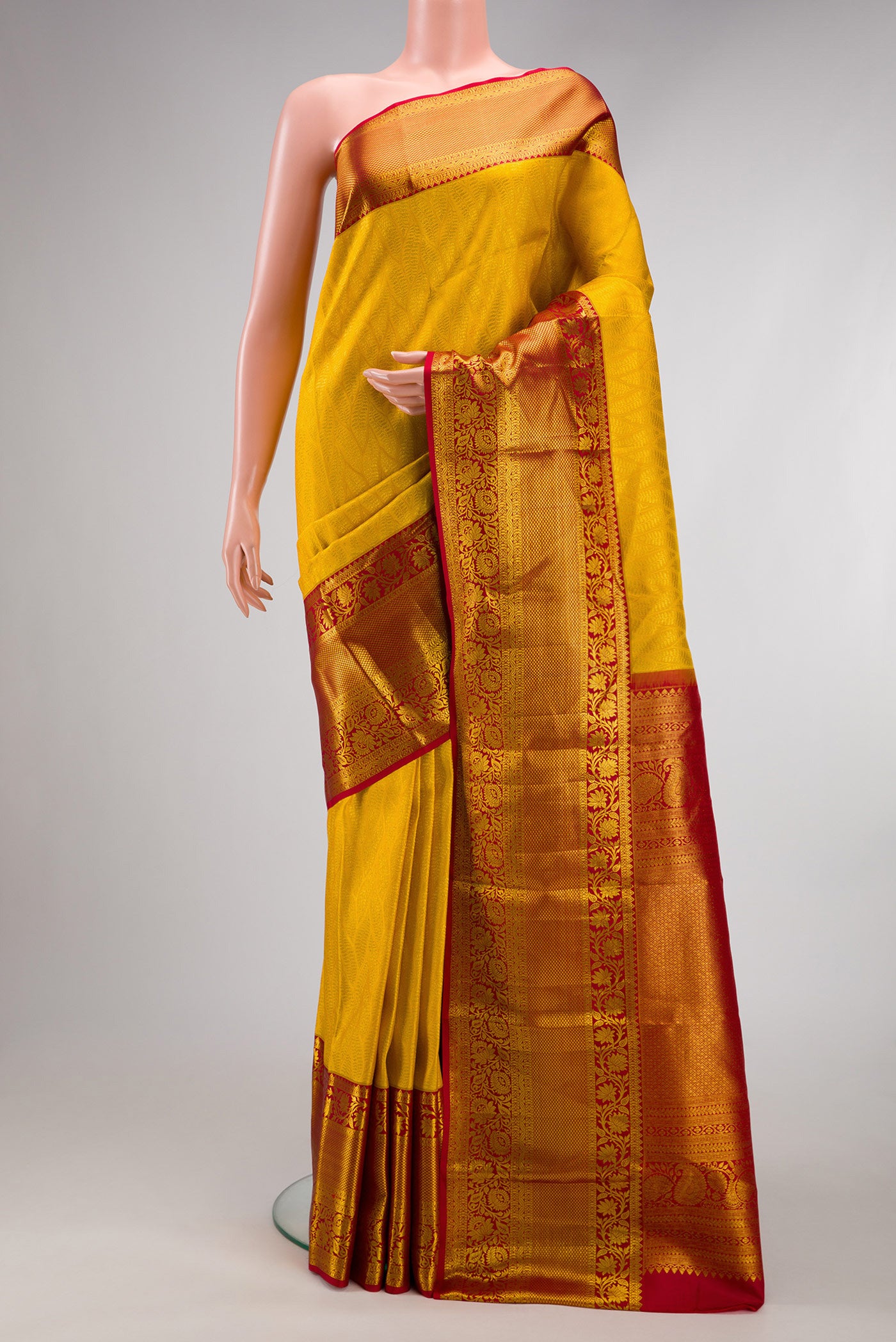 Yellow Dual Tone Kanchipuram Silk Saree with Zari Brocade on the body and Zari Border.  displayed on a mannequin