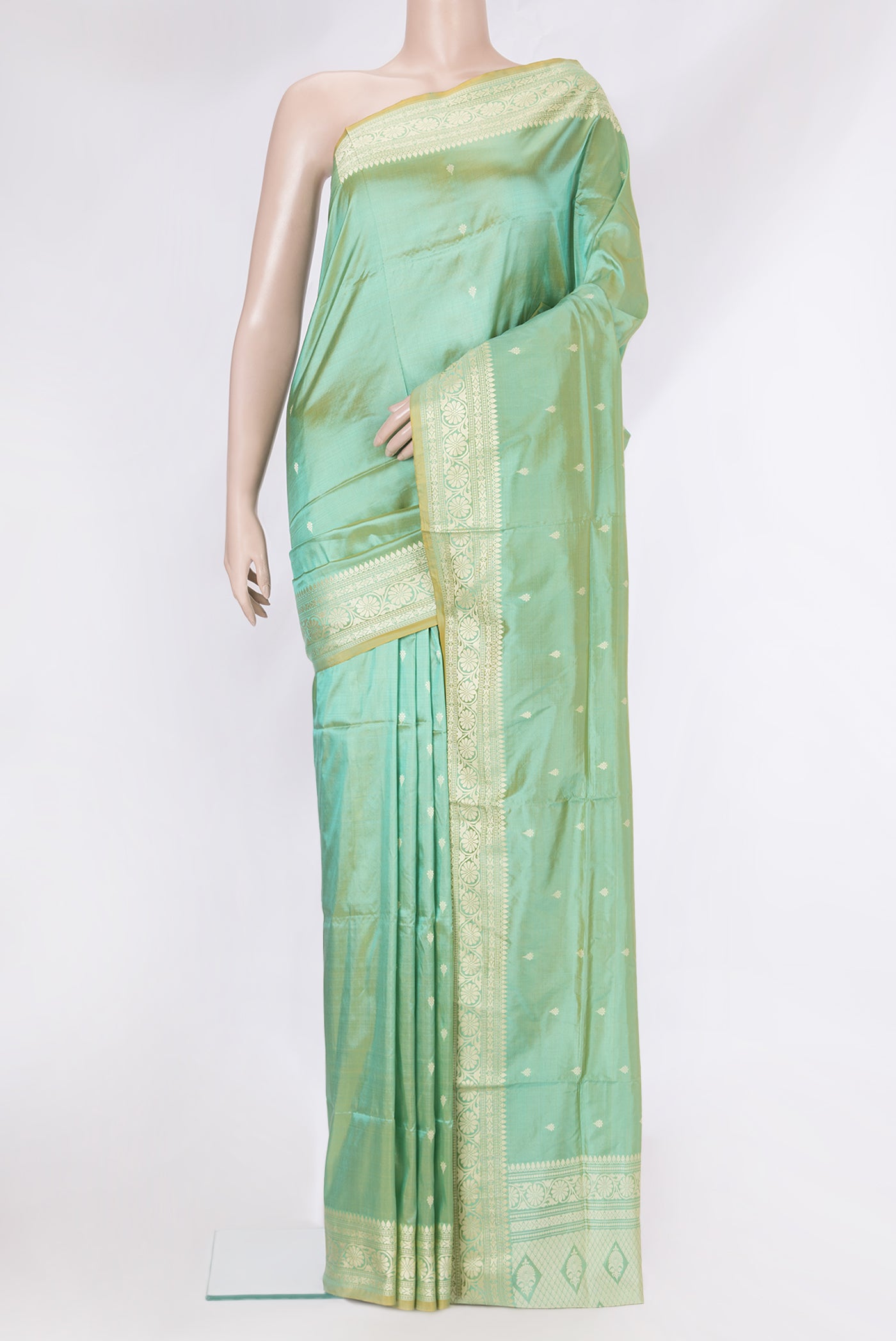 Light Green Banarasi Silk Saree with Thread Butta on the body and Thread Border.  displayed on a mannequin