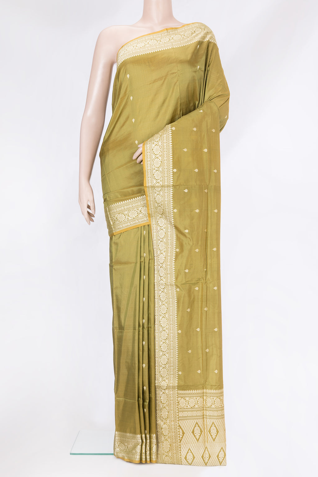 Mehandi Green Banarasi Silk Saree with Thread Butta on the body and Thread Border.  displayed on a mannequin