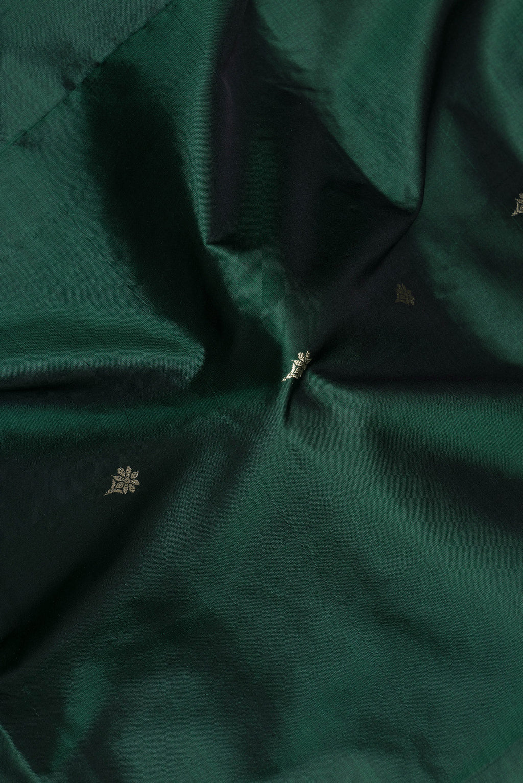 Close up of Bottle Green Banarasi Silk Saree with Thread Butta on the body and Thread Border.  displaying folds