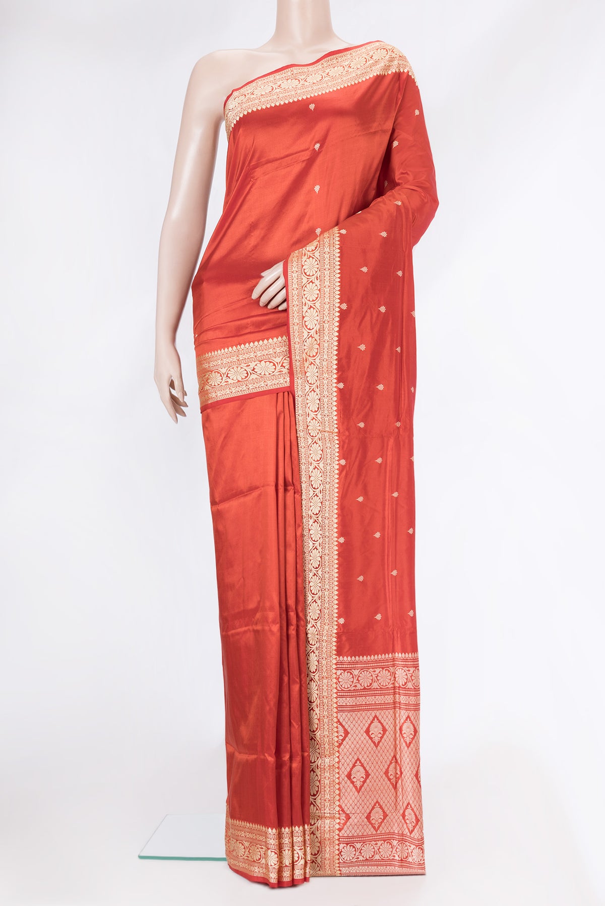 Brick Orange Dual Tone Banarasi Silk Saree with Thread Butta on the body and Thread Border.  displayed on a mannequin