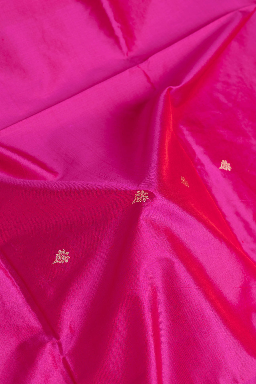 Close up of Pink Dual Tone Banarasi Silk Saree with Thread Butta on the body and Thread Border.  displaying folds