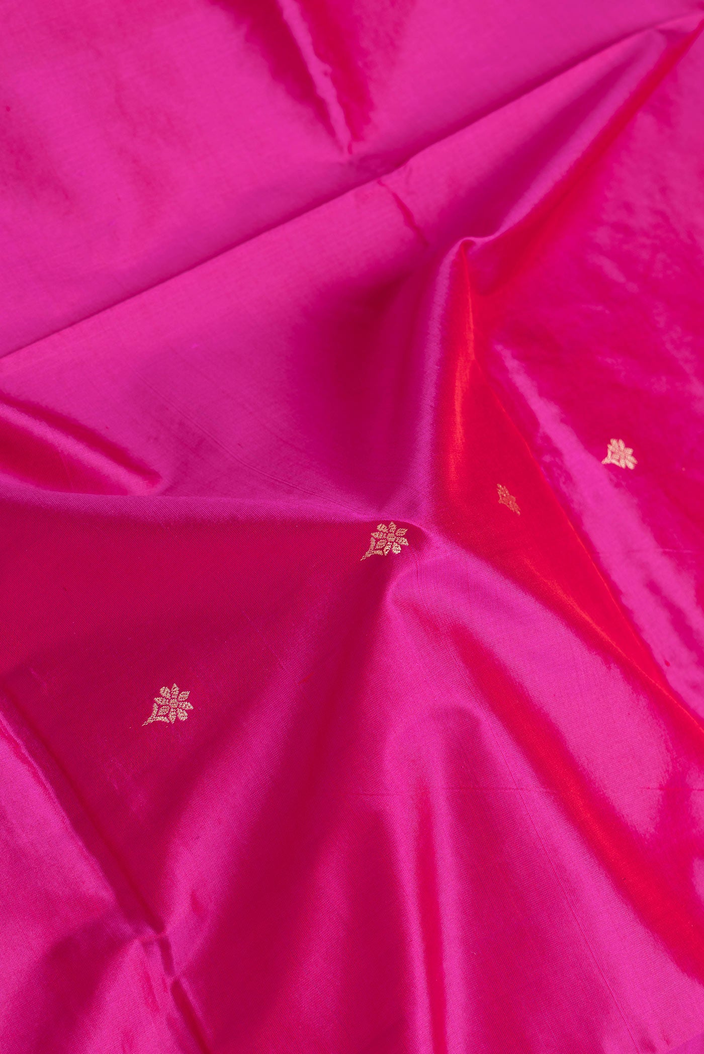 Close up of Pink Dual Tone Banarasi Silk Saree with Thread Butta on the body and Thread Border.  displaying folds