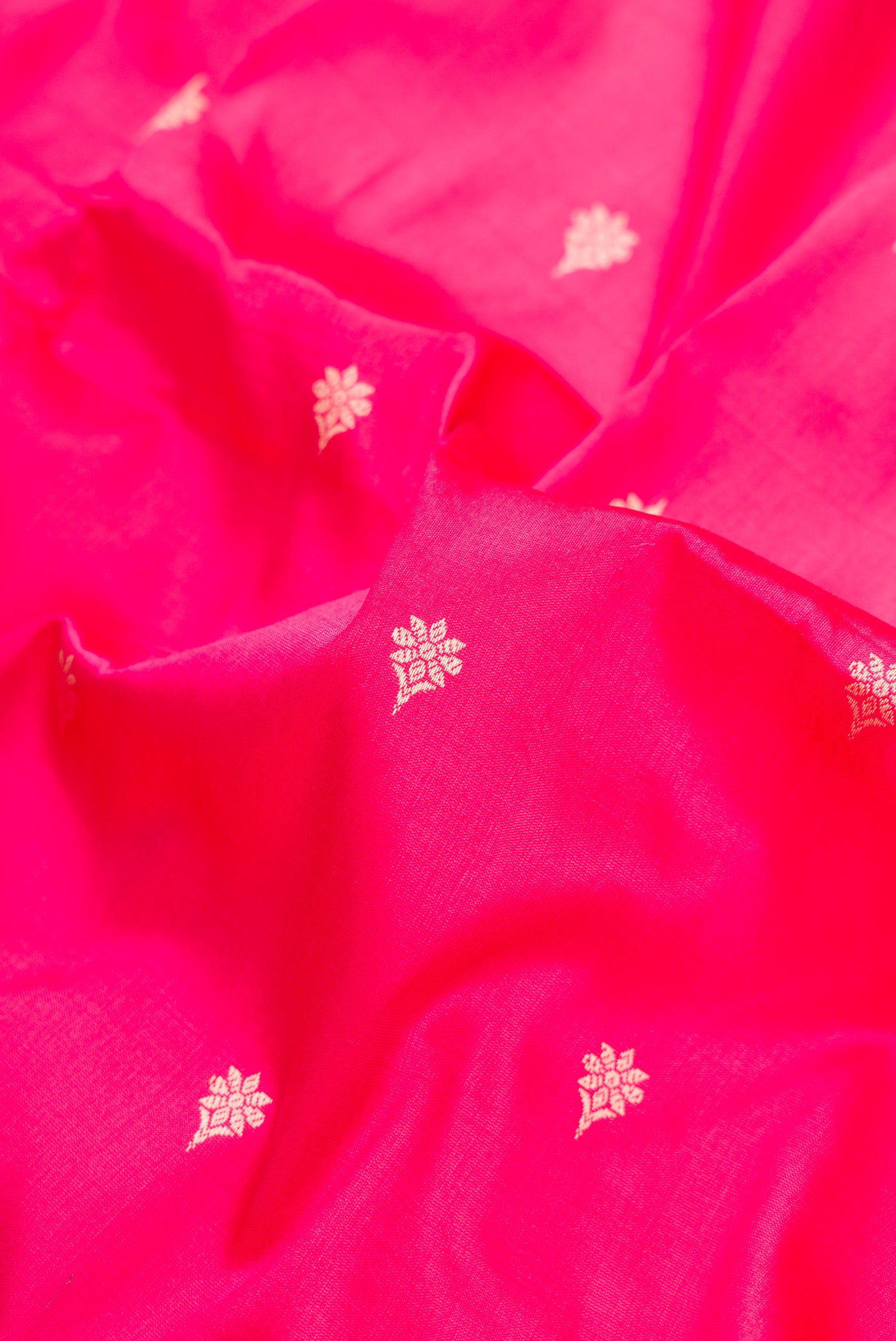 Close up of Pink Dual Tone Banarasi Silk Saree with Thread Butta on the body and Thread Border.  displaying folds