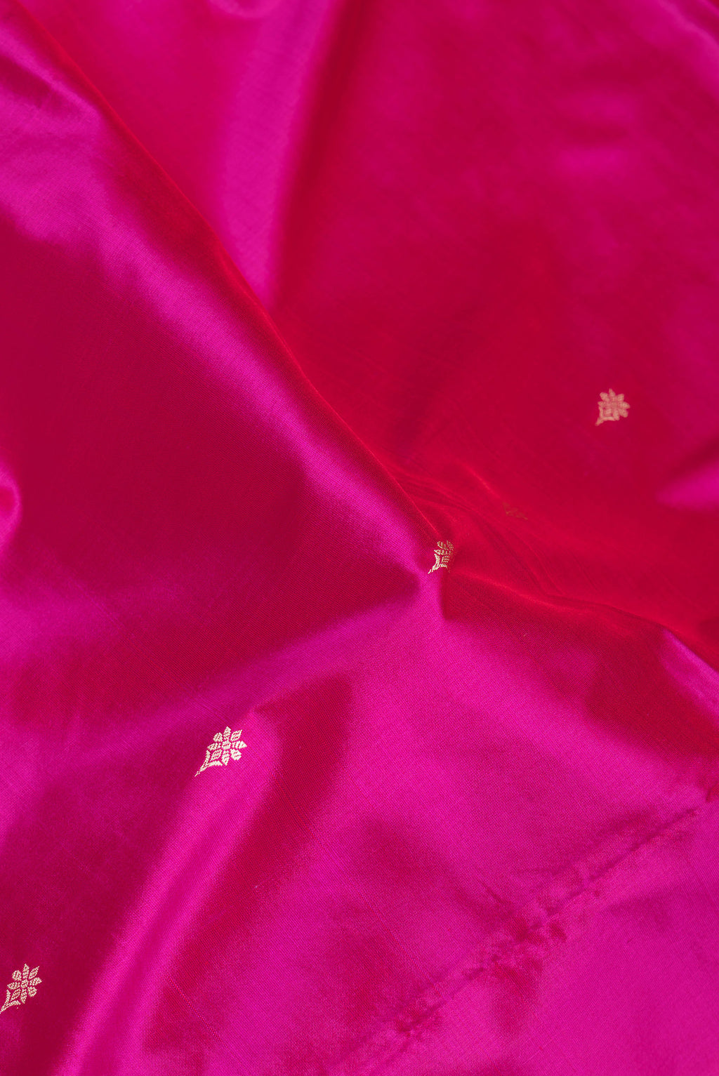 Close up of Light Magenta Banarasi Silk Saree with Thread Butta on the body and Thread Border.  displaying folds