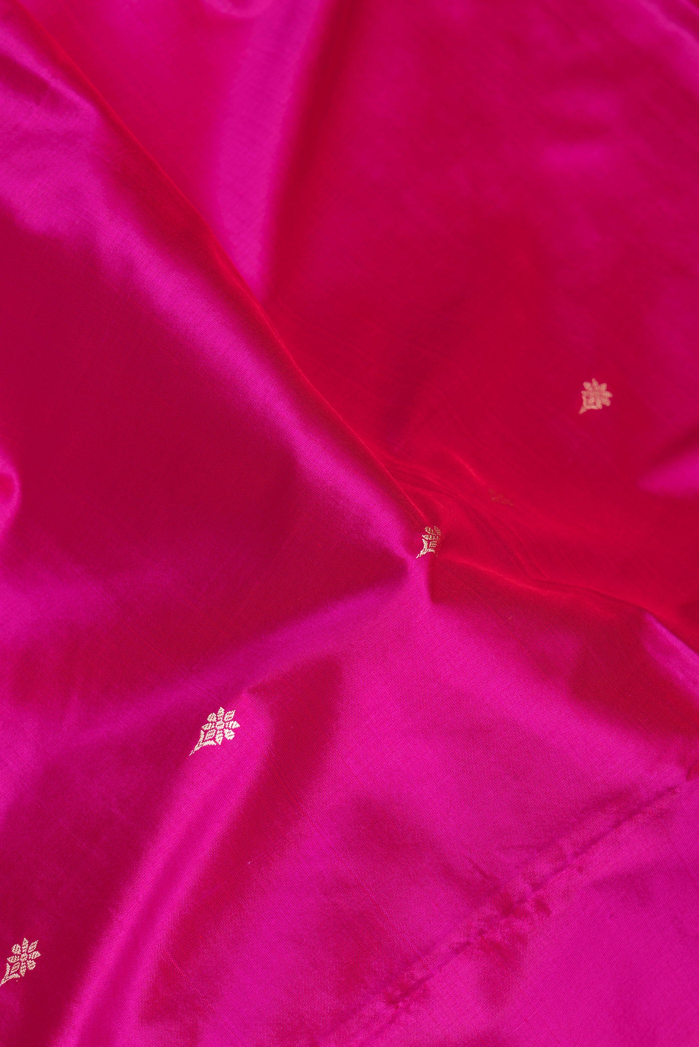 Close up of Light Magenta Banarasi Silk Saree with Thread Butta on the body and Thread Border.  displaying folds