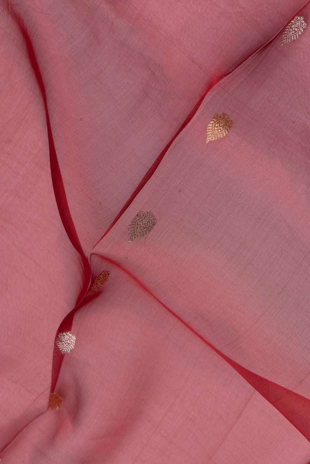 Close up of Red Dual Tone Organza Silk Saree with Zari Butta on the body and Zari Border.  displaying folds