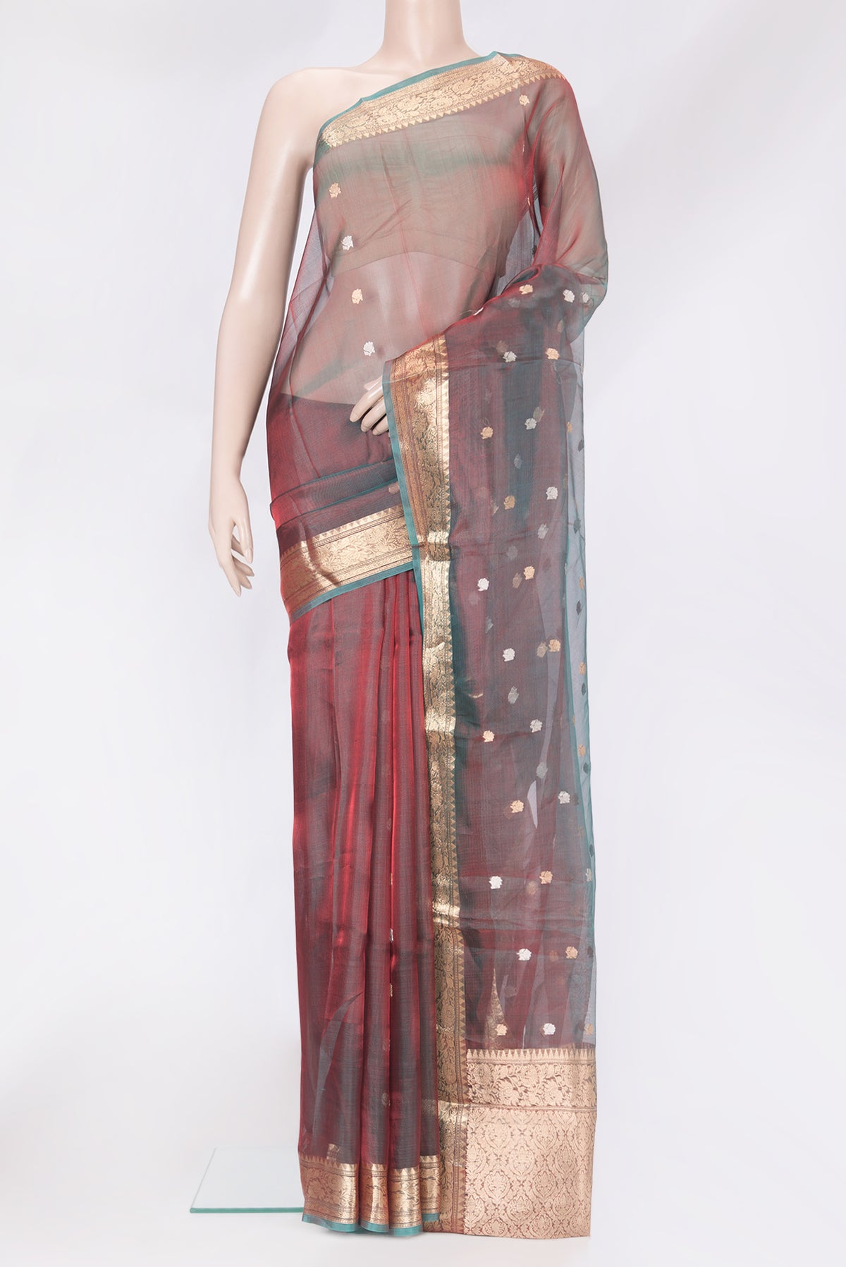 Green Dual Tone Organza Silk Saree with Zari Butta on the body and Zari Border.  displayed on a mannequin