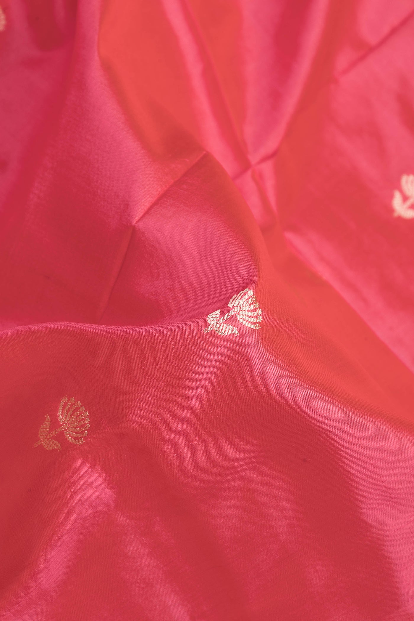 Close up of Pink Dual Tone Banarasi Silk Saree with Thread Butta on the body and Thread Border.  displaying folds