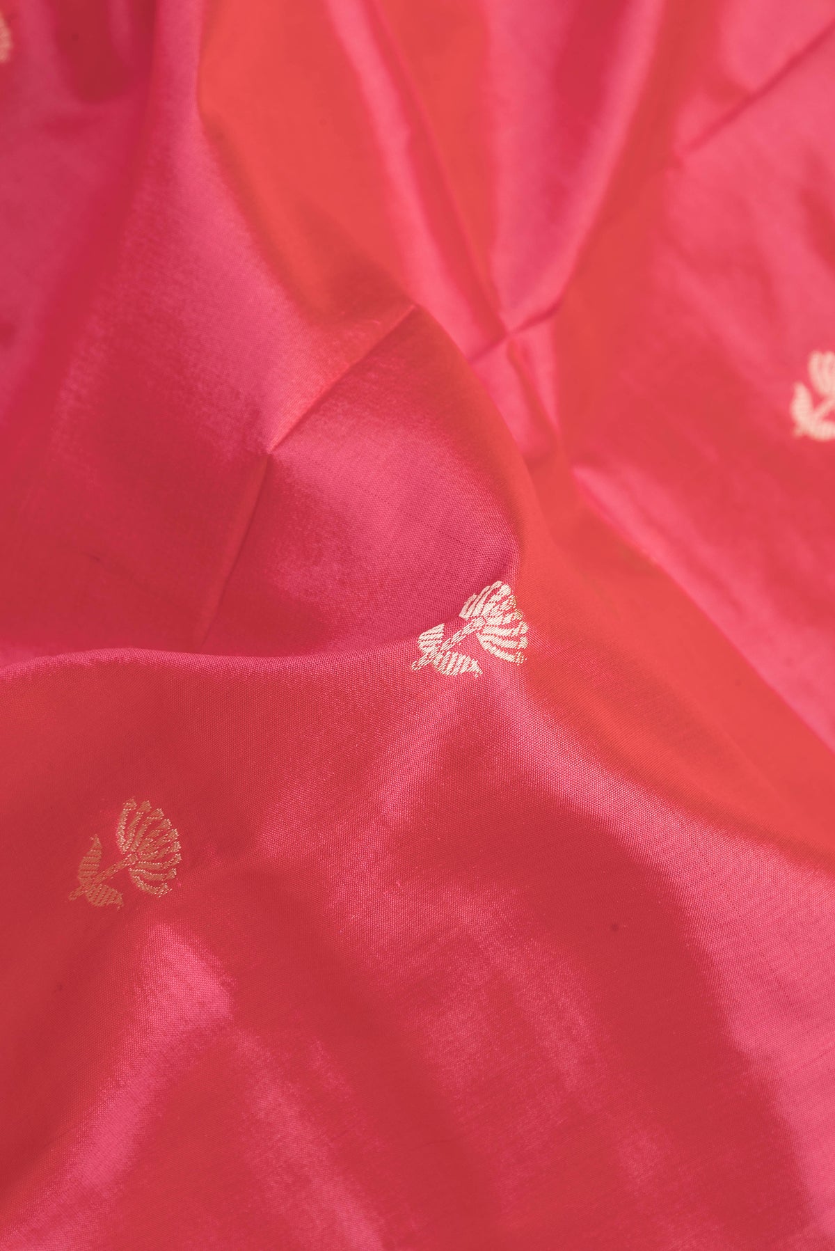 Close up of Pink Dual Tone Banarasi Silk Saree with Thread Butta on the body and Thread Border.  displaying folds