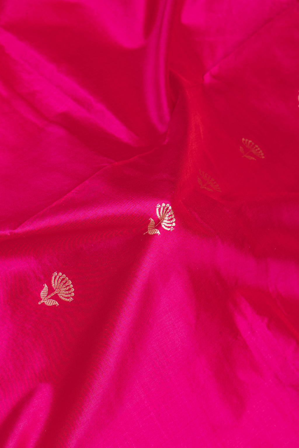 Close up of Pink Banarasi Silk Saree with Thread Butta on the body and Thread Border.  displaying folds