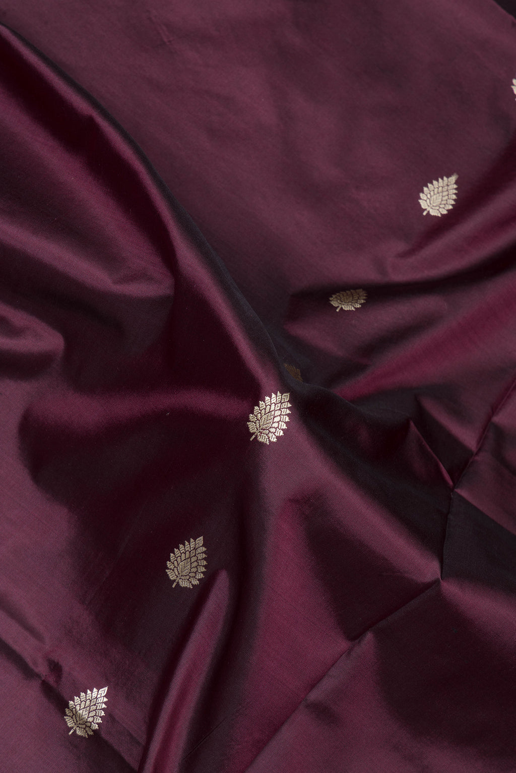 Close up of Coffee Brown Banarasi Silk Saree with Thread Butta on the body and Thread Border.  displaying folds