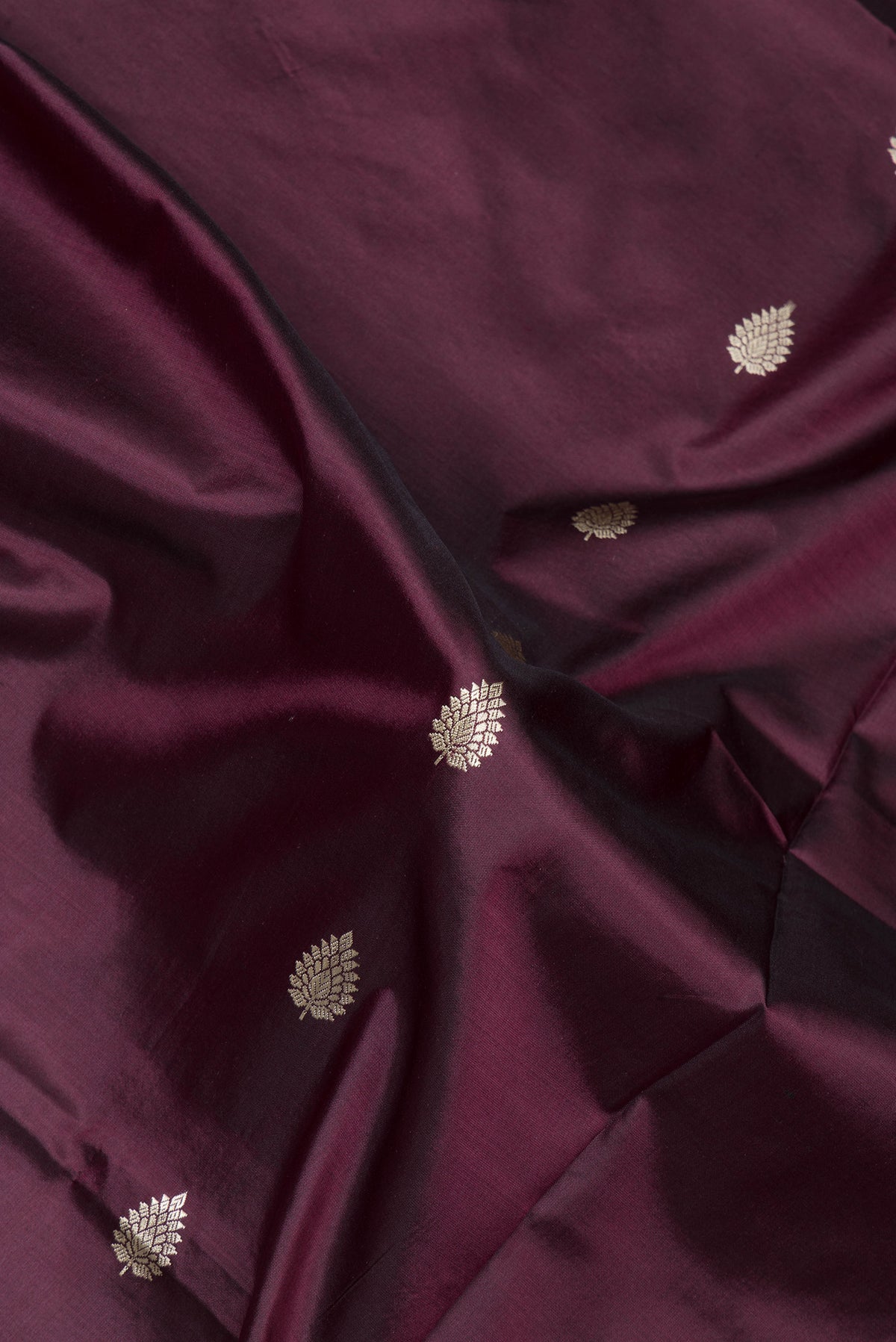 Close up of Coffee Brown Banarasi Silk Saree with Thread Butta on the body and Thread Border.  displaying folds