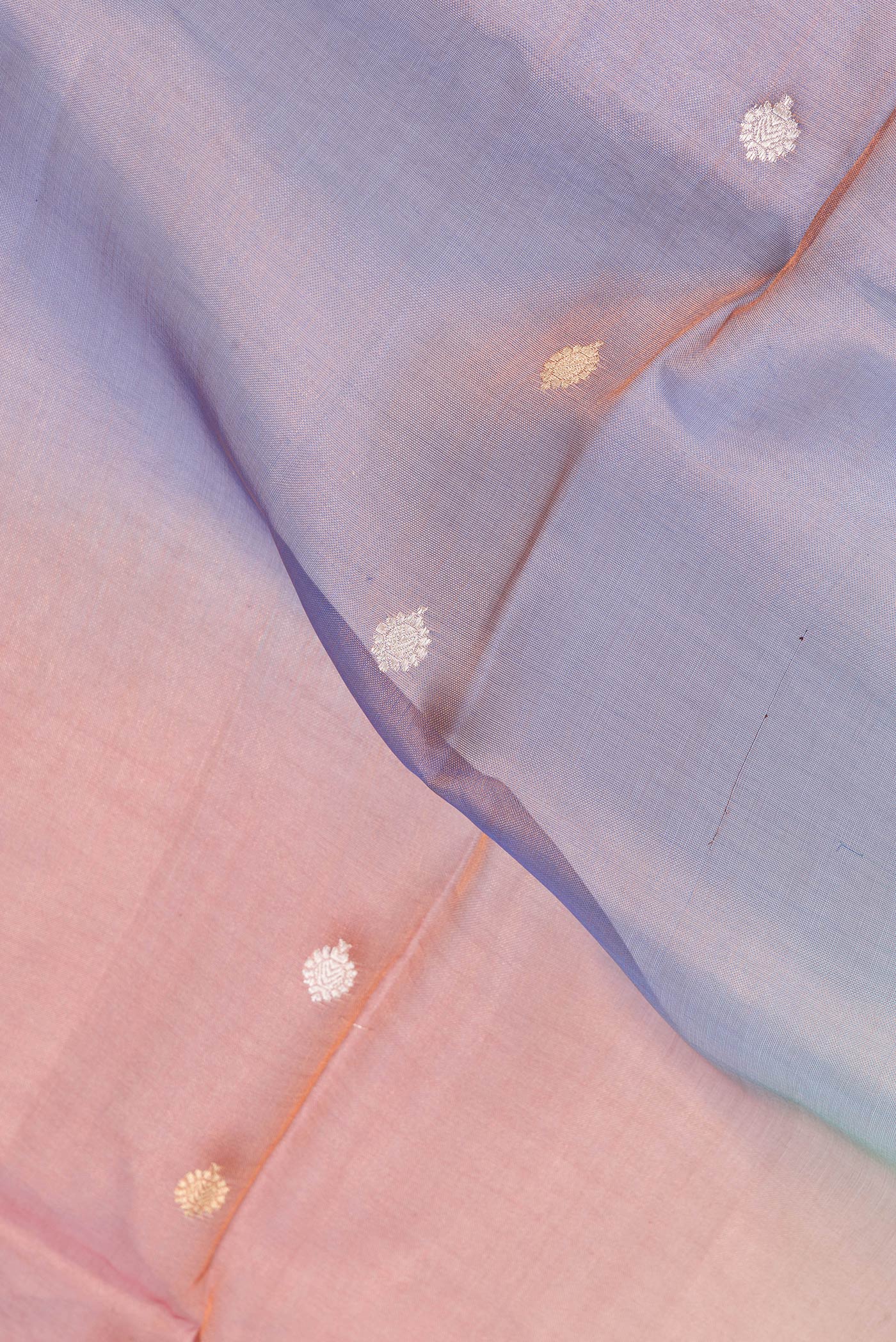Close up of Lavender and Orange Color Organza Silk Saree with Zari Butta on the body and Without Border.  displaying folds