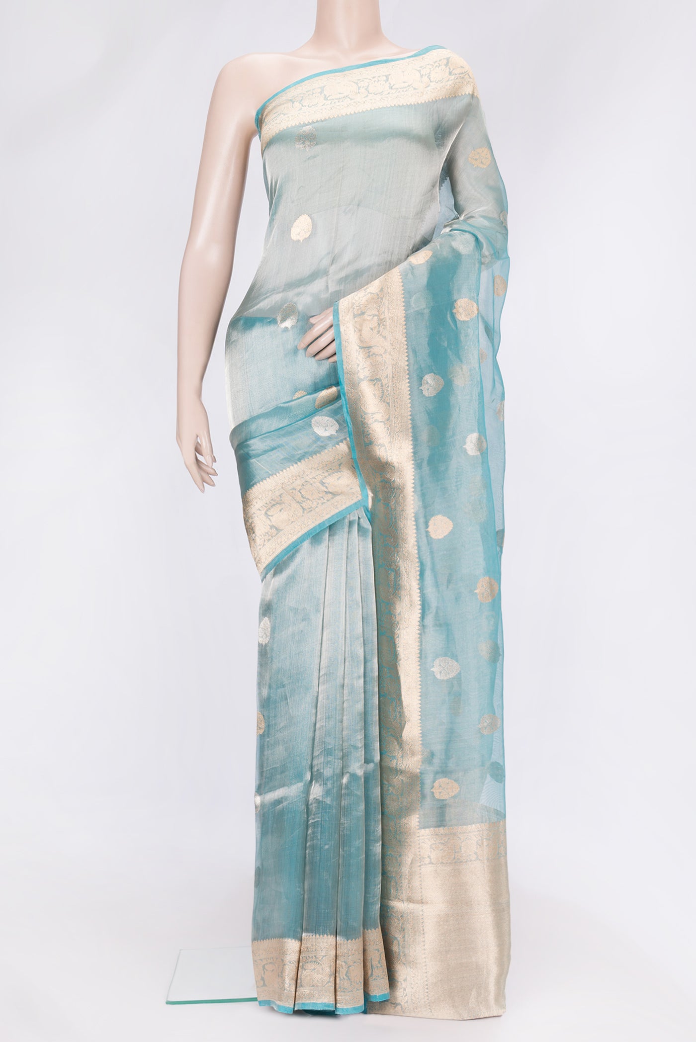 Sky Blue Dual Tone Organza Silk Saree with Zari Butta on the body and Zari Border.  displayed on a mannequin