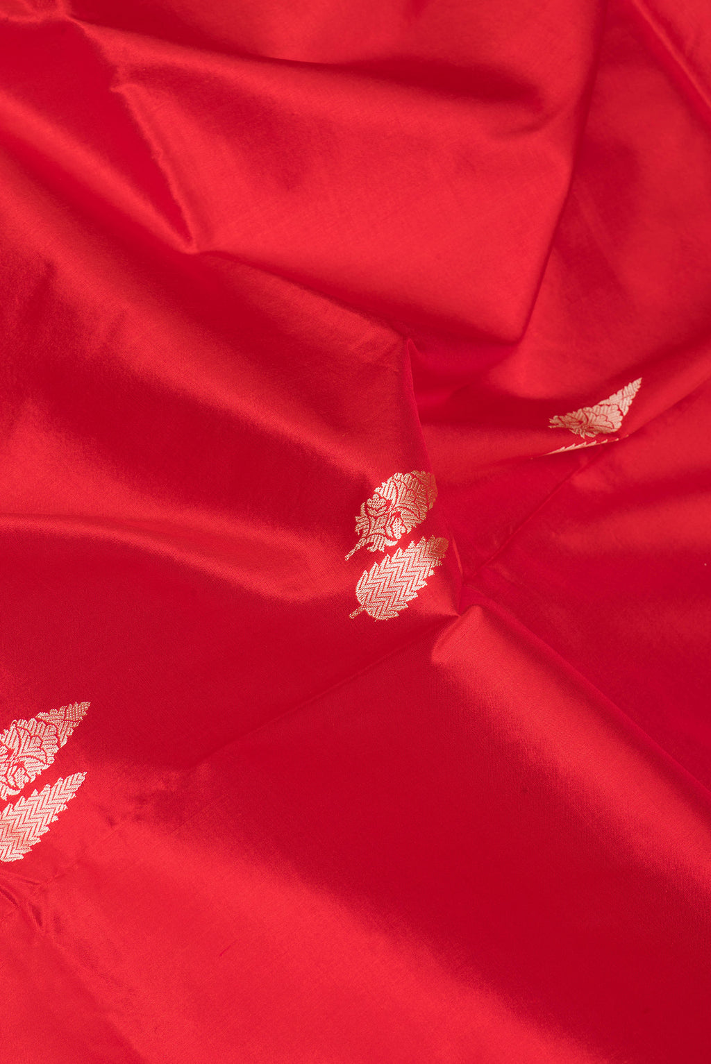 Close up of Red Banarasi Silk Saree with Thread Butta on the body and Thread Border.  displaying folds