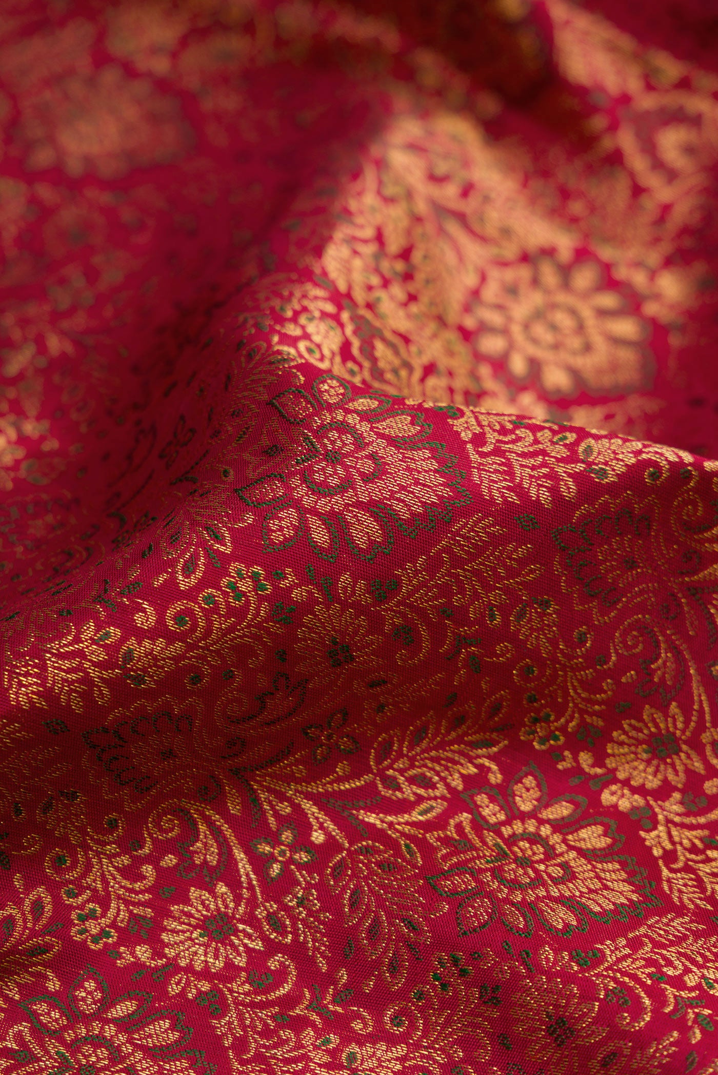 Close up of Maroon Dual Tone Kanchipuram Silk Saree with Zari Brocade on the body and Zari Border.  displaying folds