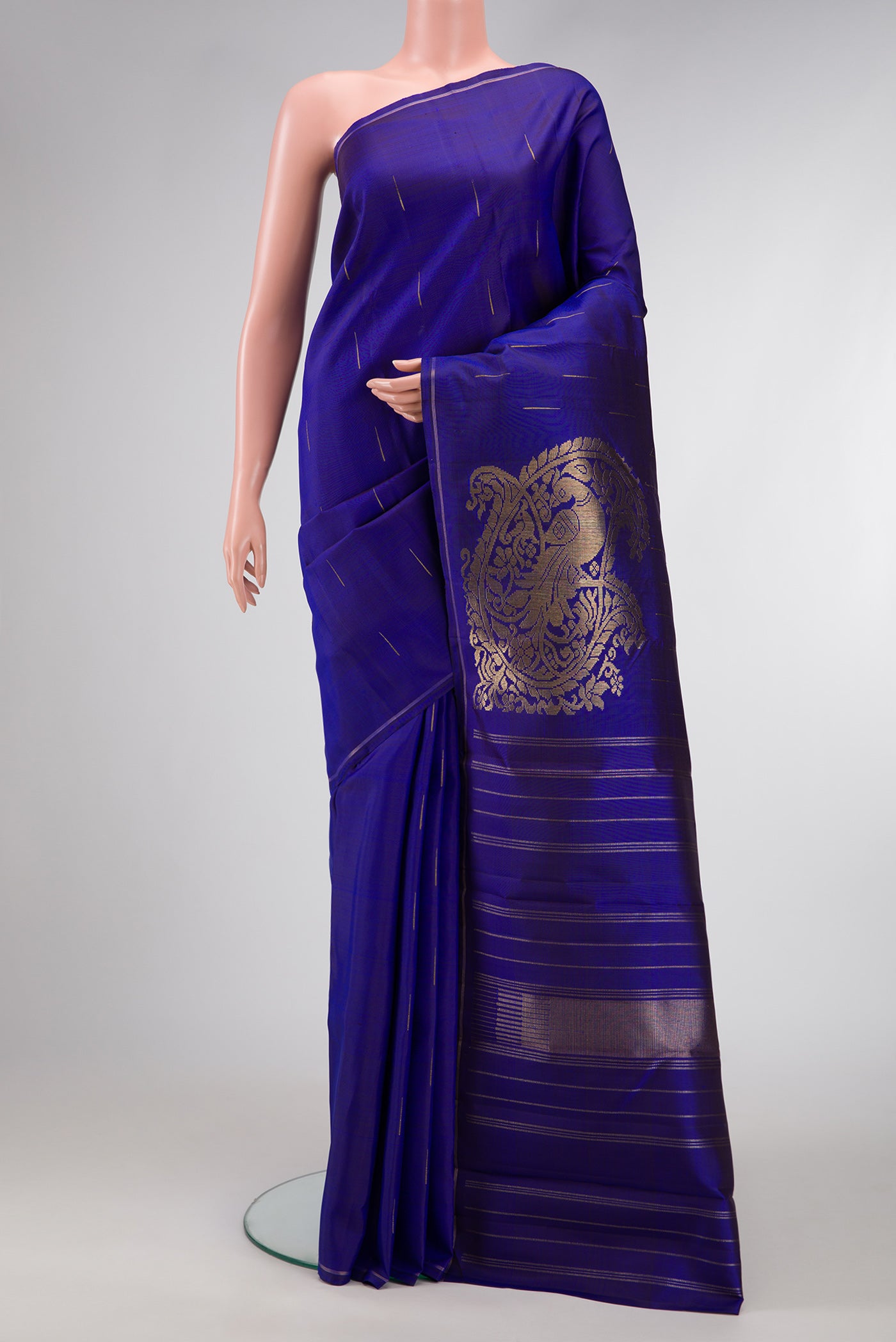 Navy Blue Dual Tone Kanjivaram Silk Saree with Zari Butta on the body and Thin Zari Line.  displayed on a mannequin