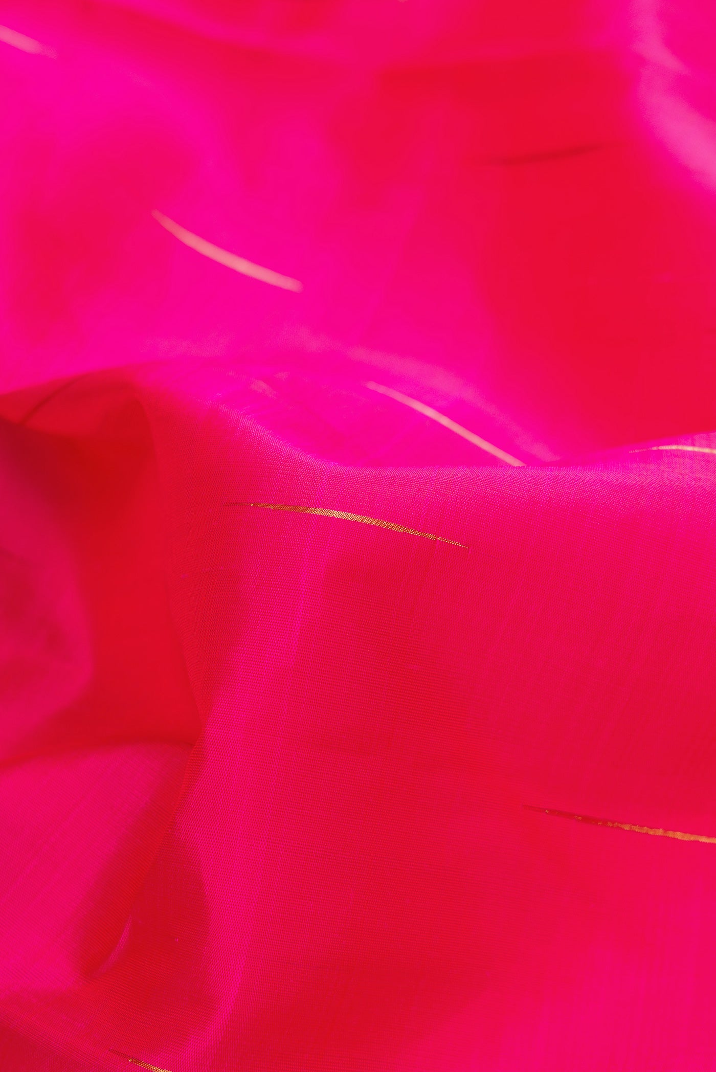 Close up of Pure Silk Pure Zari Pink Dual Tone Kanchipuram Saree with Zari Butta on the body and Zari Border.  displaying folds