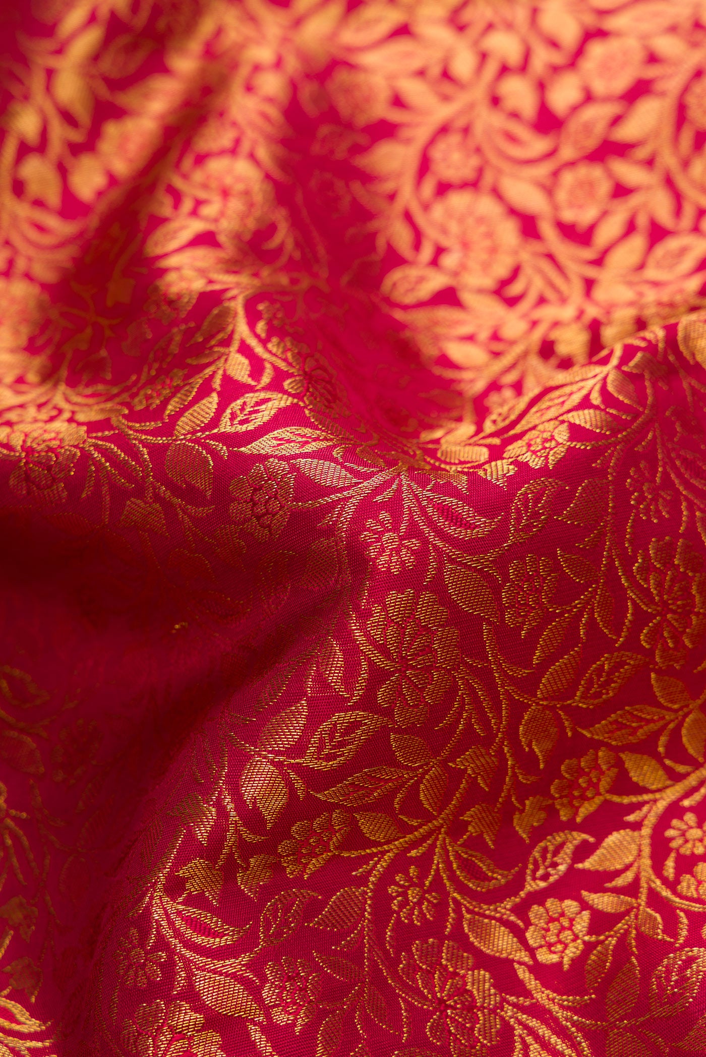 Close up of Maroon Dual Tone Kanjivaram Silk Saree with Zari Brocade on the body and Zari Border.  displaying folds