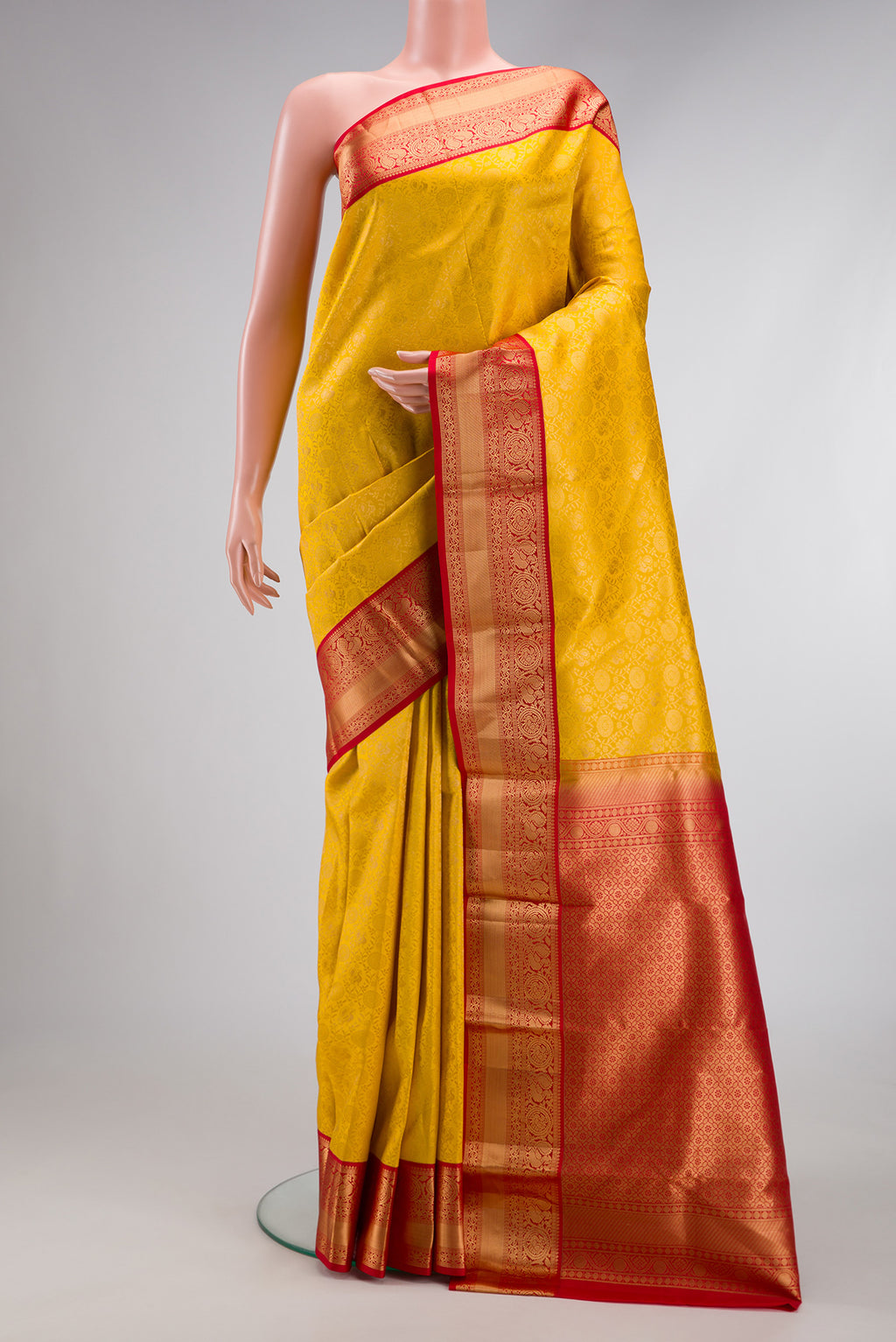 Yellow Dual Tone Kanjivaram Silk Saree with Zari Brocade on the body and Zari Border.  displayed on a mannequin