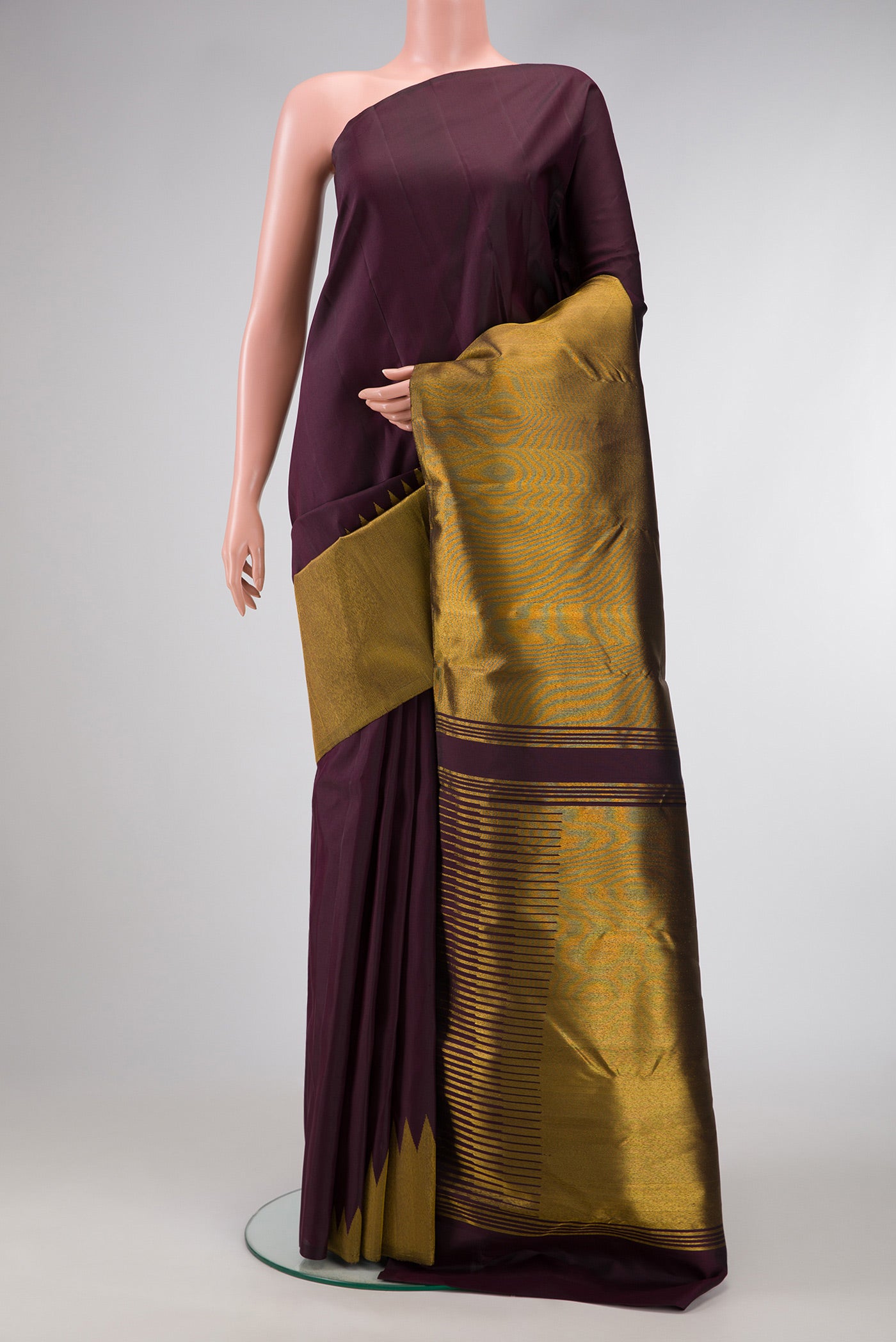 Burgundy Dual Tone Kanjivaram Silk Saree with Plain Body and Rising Temple Border.  displayed on a mannequin